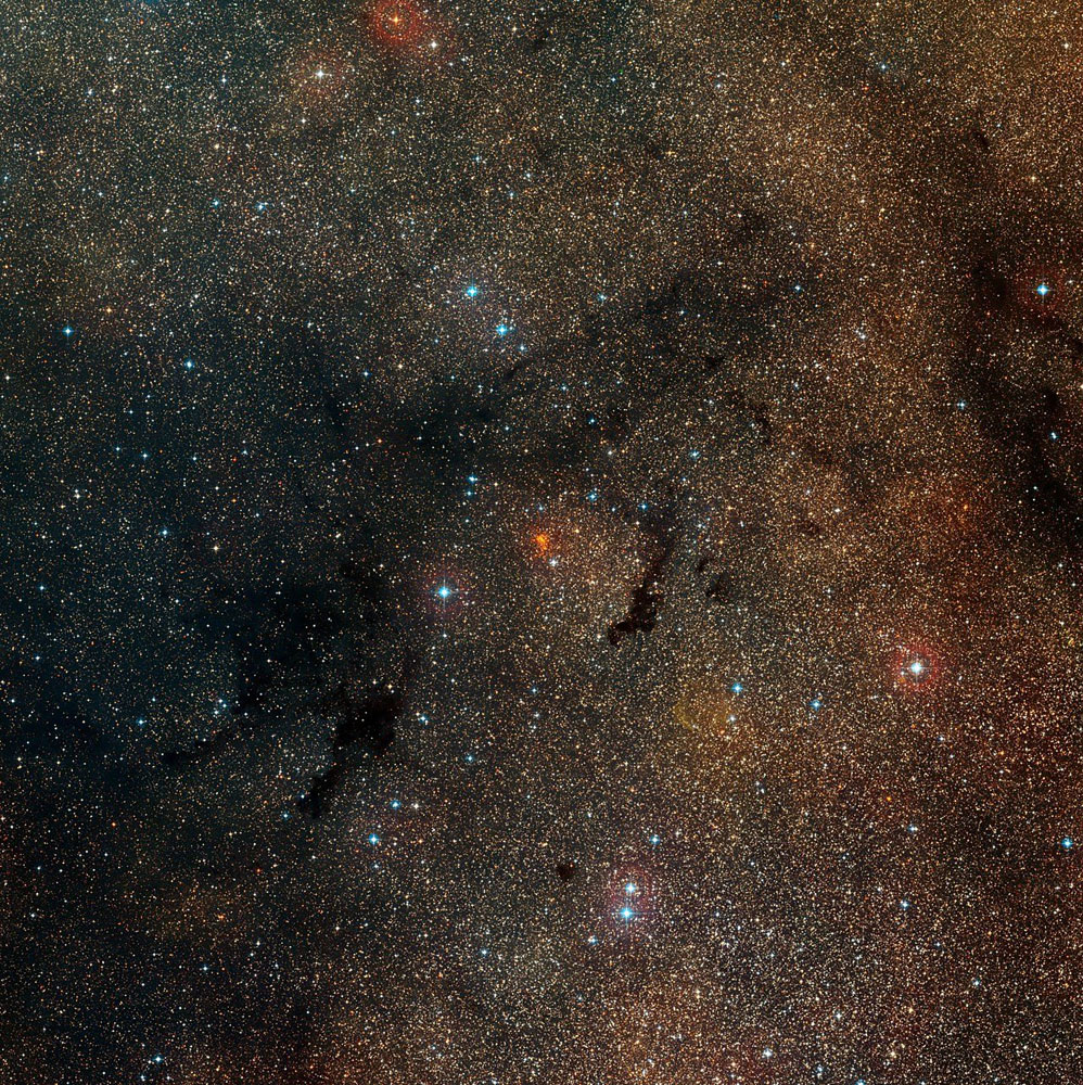The star cluster Westerlund 1, which appears as a dense orange clump at center, in the constellation of Ara (The Altar) is shown in this image released on May 13, 2014.