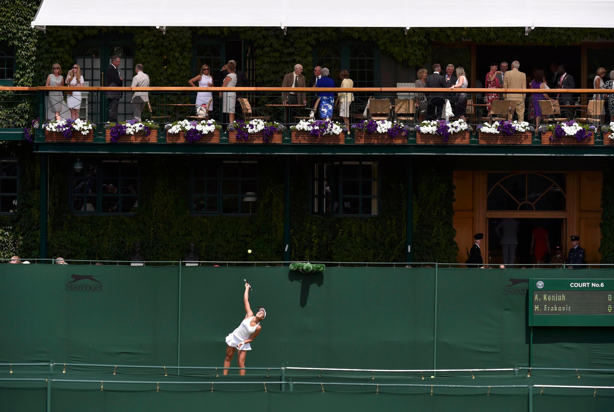 Marina Erakovic of New Zealand serves to Ana Konjuh of Croatia during their women's singles tennis match at the Wimbledon Tennis Championships, in London