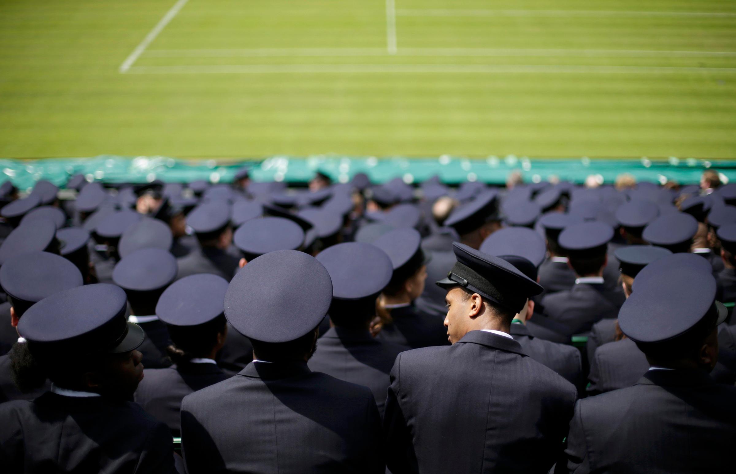 Stewards sit together for a meeting the day before the start of the Wimbledon Tennis Championships, in London
