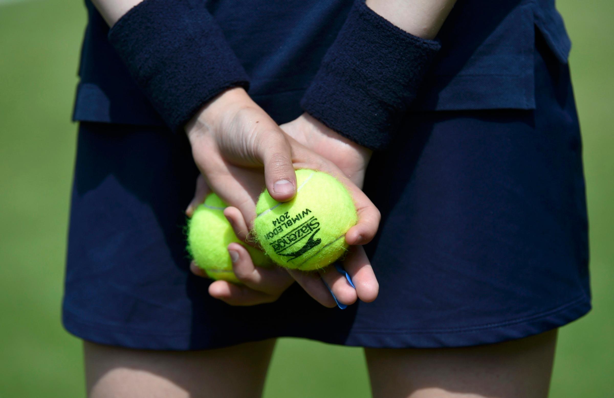 A ball-girl holds tennis balls at the Wimbledon Tennis Championships, in London