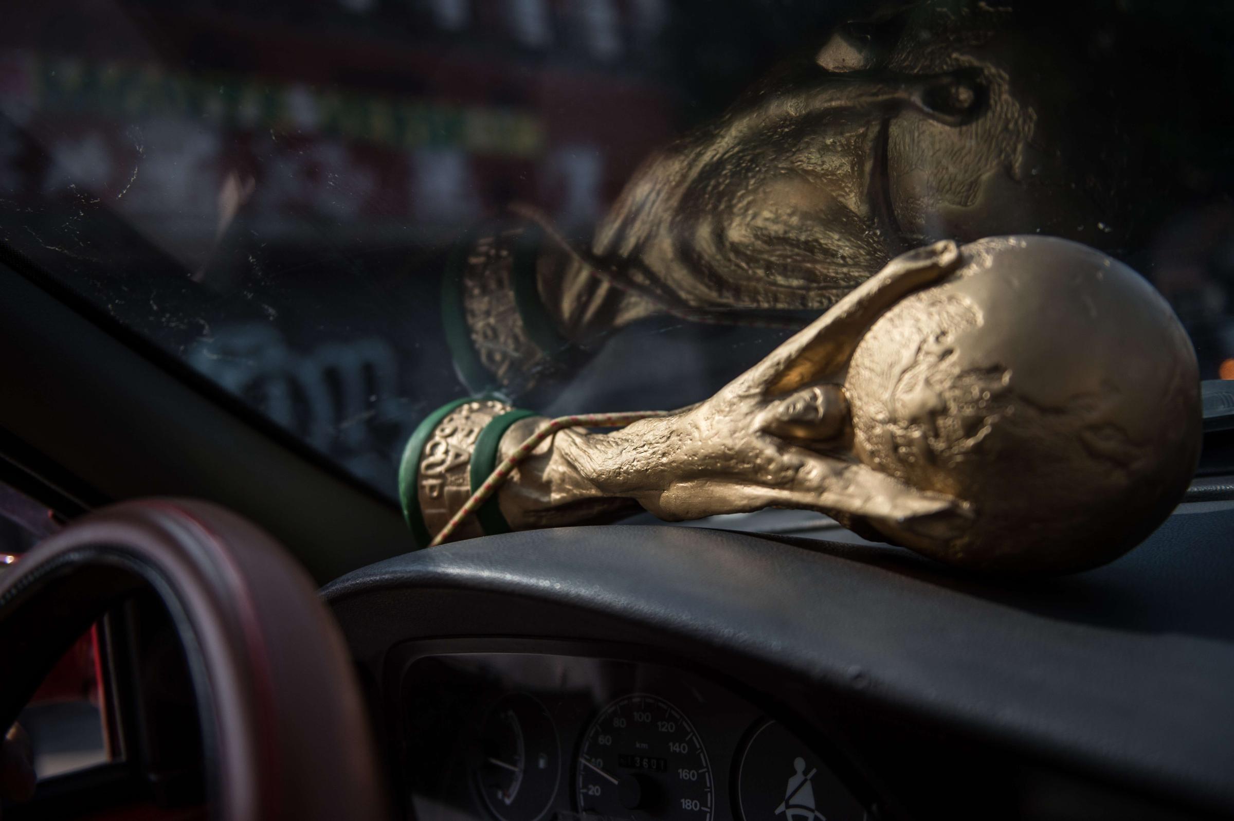 Jarbas Menighini has one of his hand made trophies in his car on the day he is to see the first of four matches of the FIFA World Cup at Maracana stadium in Rio de Janeiro, Brazil, on June 18, 2014.