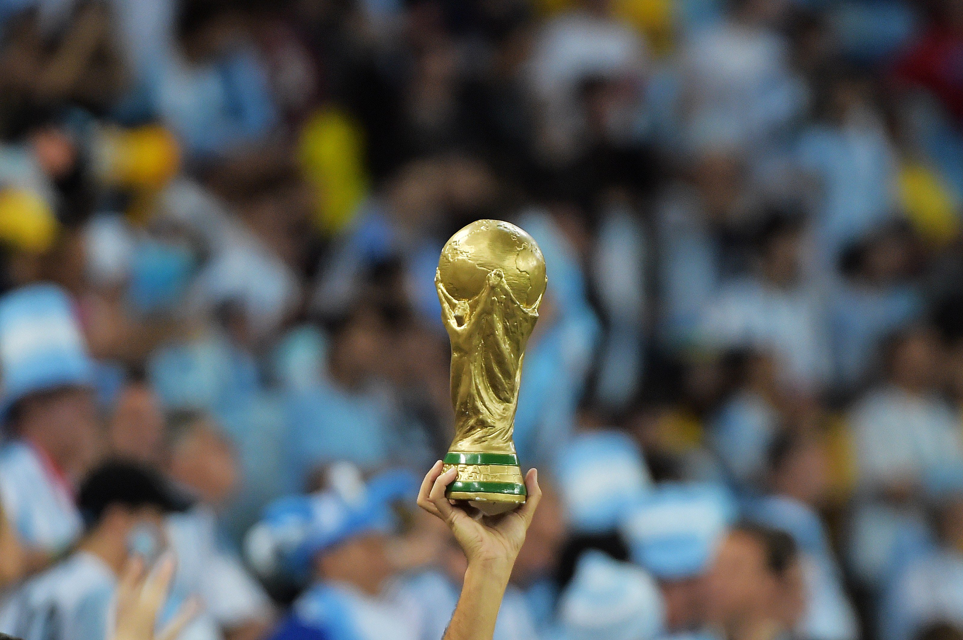 An Argentine fan holds a replica of the World Cup trophy before the start of a Group F football match between Argentina and Bosnia Hercegovina at the Maracana Stadium in Rio De Janeiro during the 2014 FIFA World Cup on June 15, 2014.
