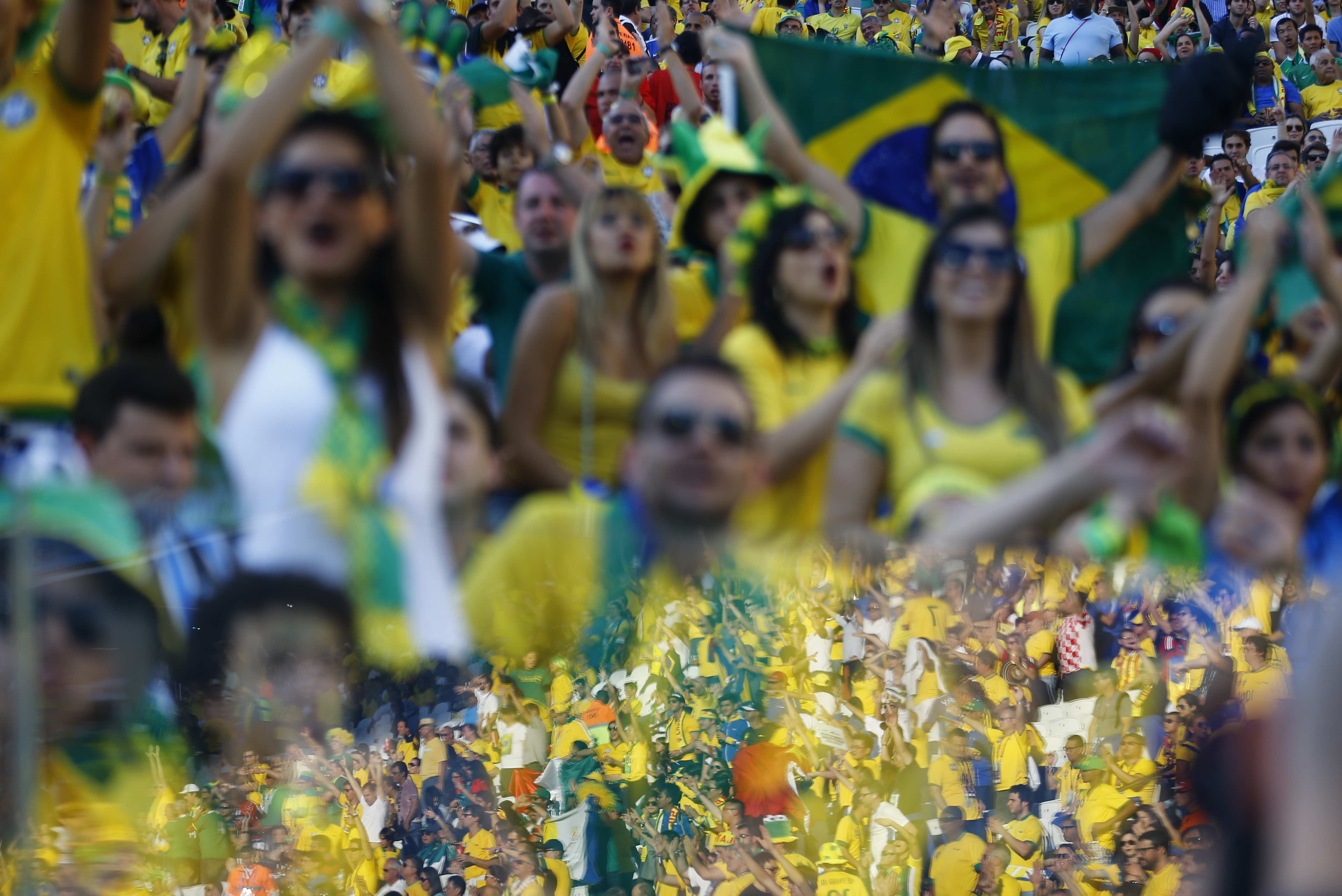 A reflection of cheering fans is seen before the 2014 World Cup opening match between Brazil and Croatia at the Corinthians arena in Sao Paulo on June 12, 2014.