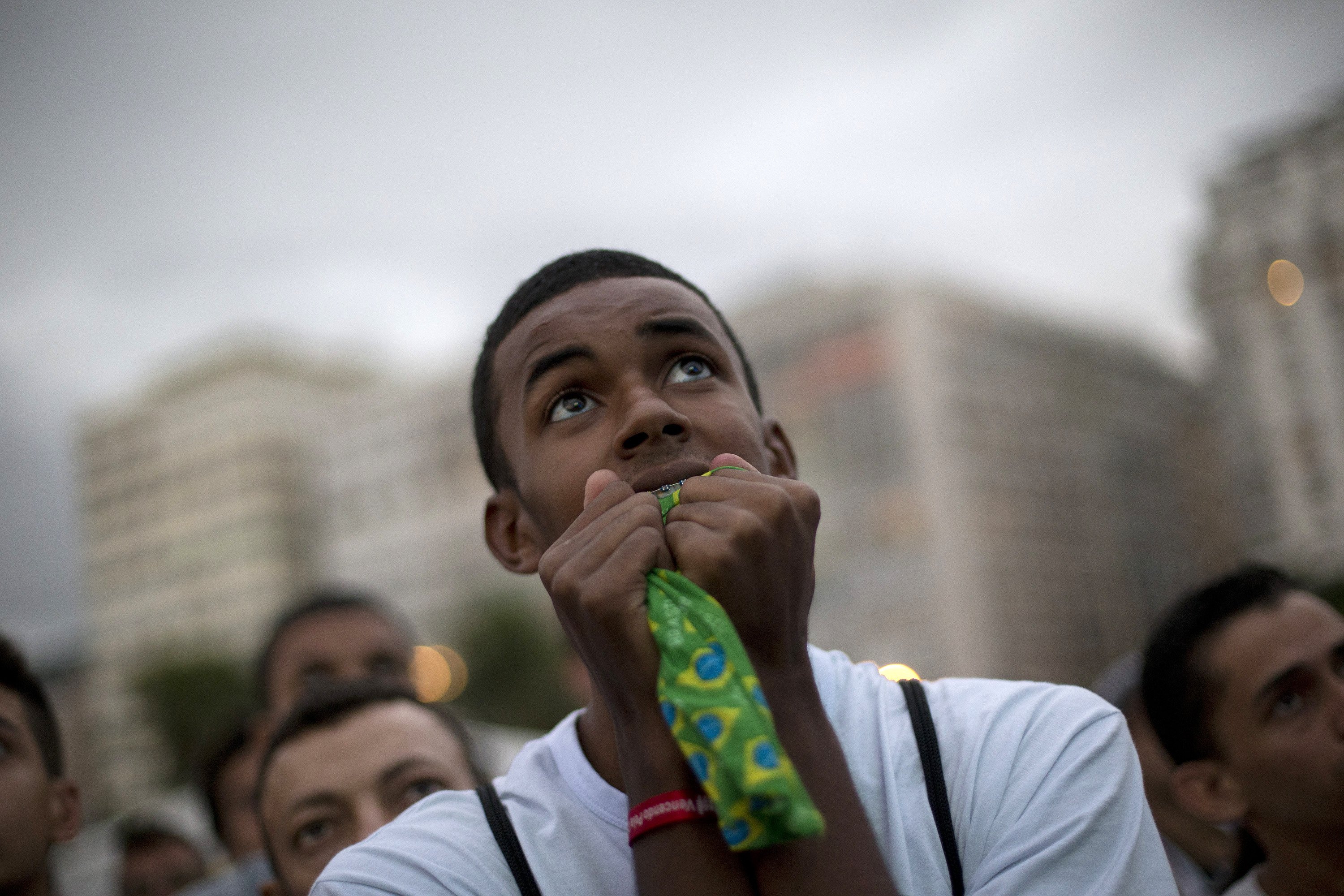 A Brazil soccer fan watches a screen broadcasting the World Cup opening match between Brazil and Croatia inside the FIFA Fan Fest area on Copacabana beach in Rio de Janeiro on June 12, 2014.