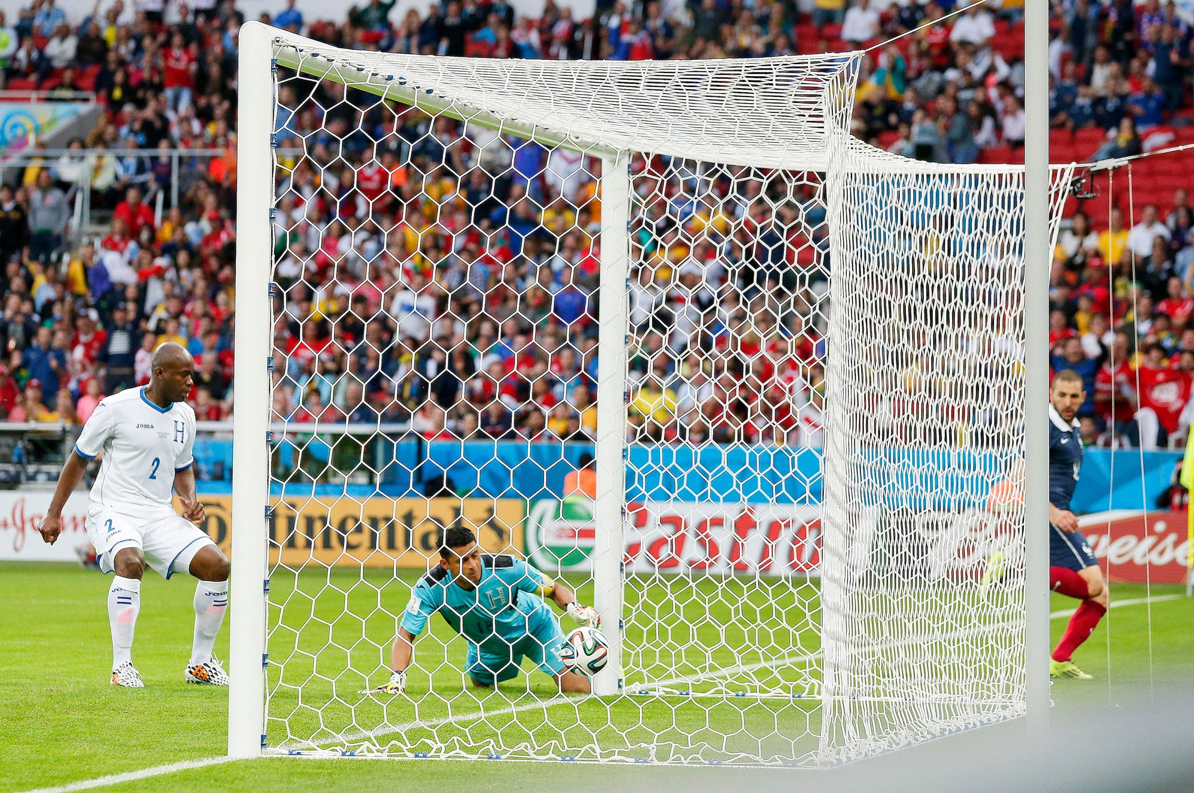 Honduras' goalkeeper Noel Valladares bundles a shot from France's Karim Benzema, far right, into his net for an own goal during the group E World Cup soccer match between France and Honduras at the Estadio Beira-Rio in Porto Alegre, Brazil on June 15, 2014.