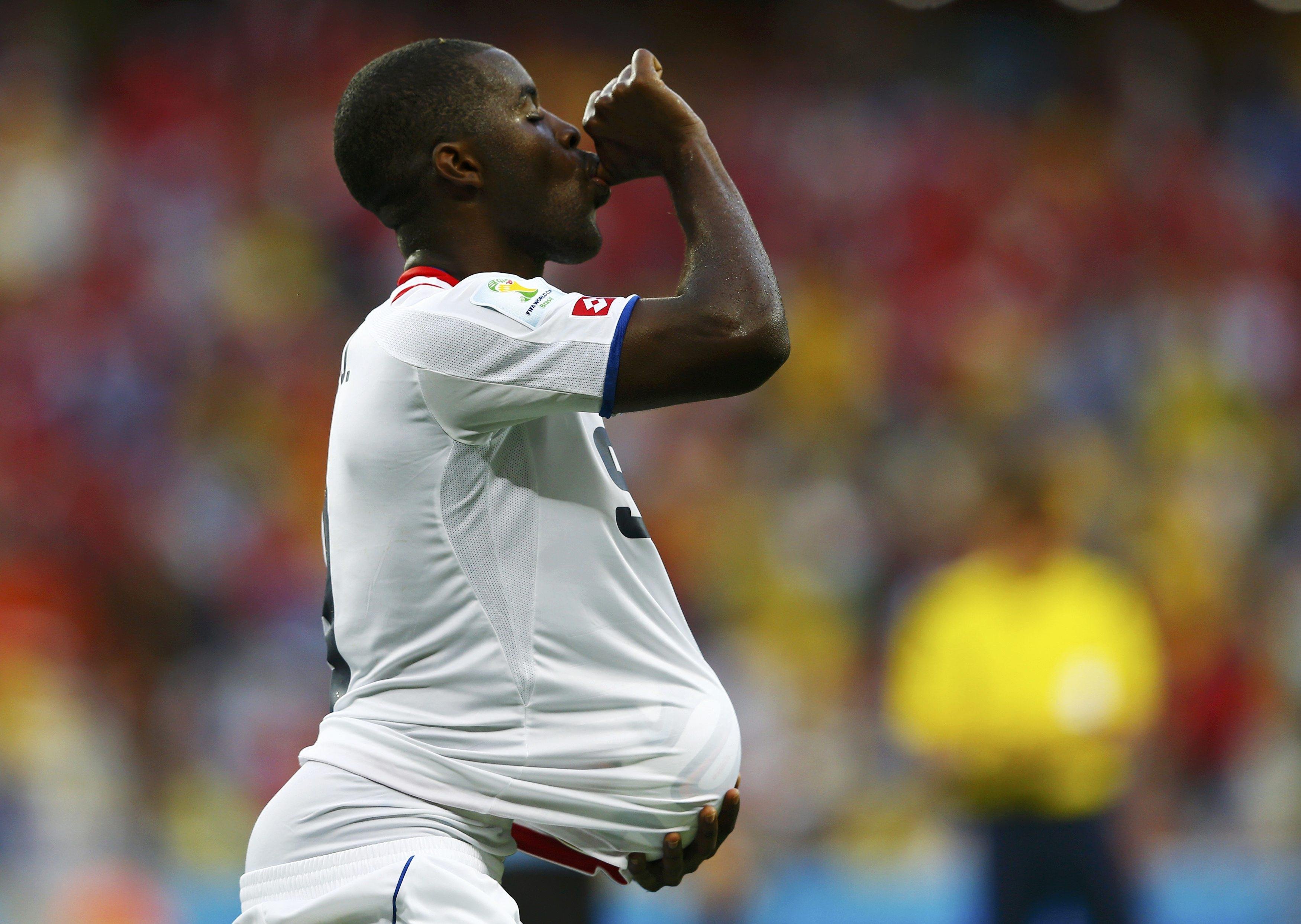 Costa Rica's Joel Campbell celebrates with the match ball after scoring against Uruguay during their 2014 World Cup Group D soccer match at the Castelao stadium in Fortaleza on June 14, 2014.