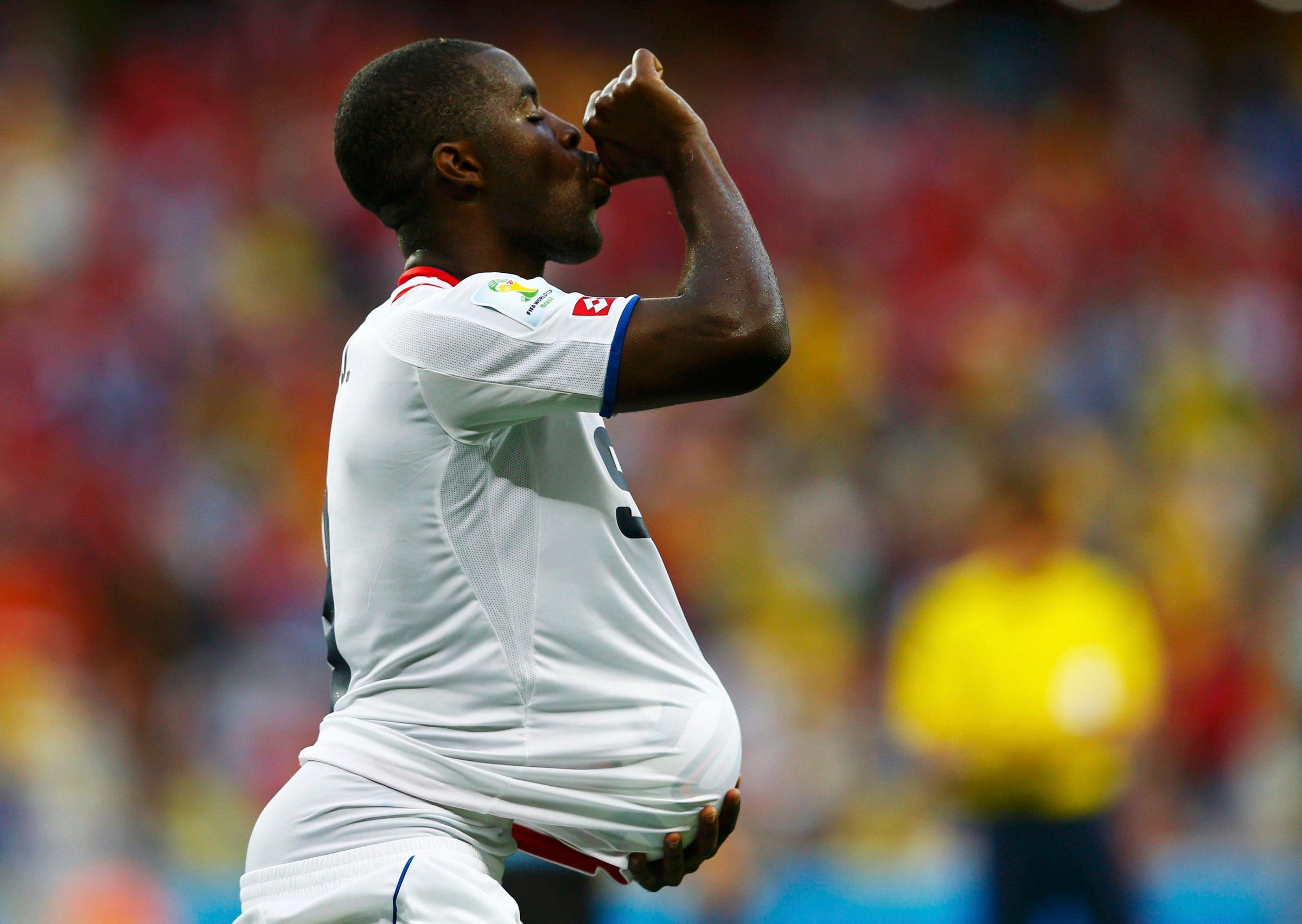 Costa Rica's Joel Campbell celebrates with the match ball after scoring against Uruguay during their 2014 World Cup Group D soccer match at the Castelao stadium in Fortaleza on June 14, 2014.