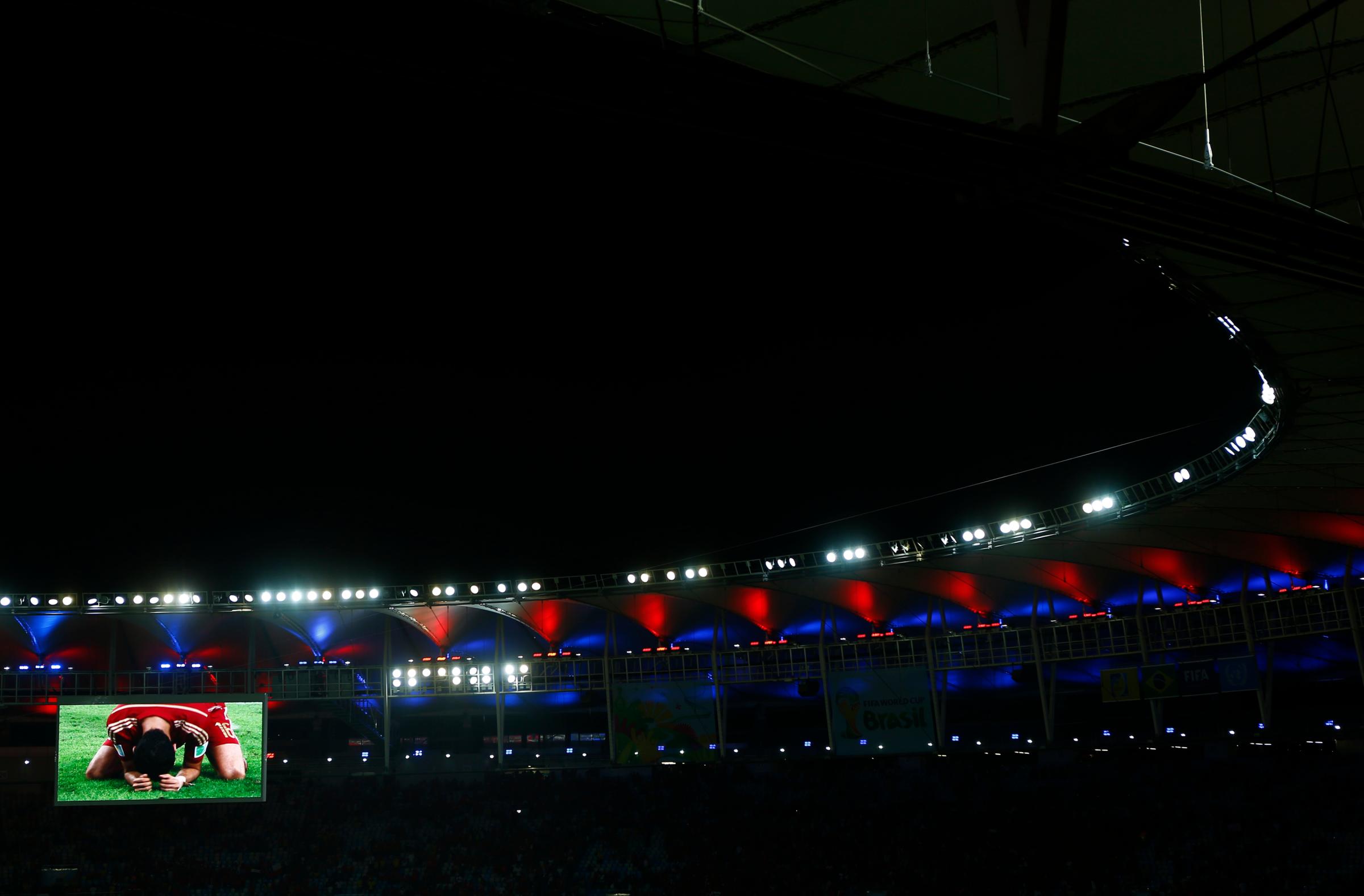 Match highlights are screened after the 2014 World Cup Group B soccer match between Spain and Chile at the Maracana stadium in Rio de Janeiro on June 18, 2014.