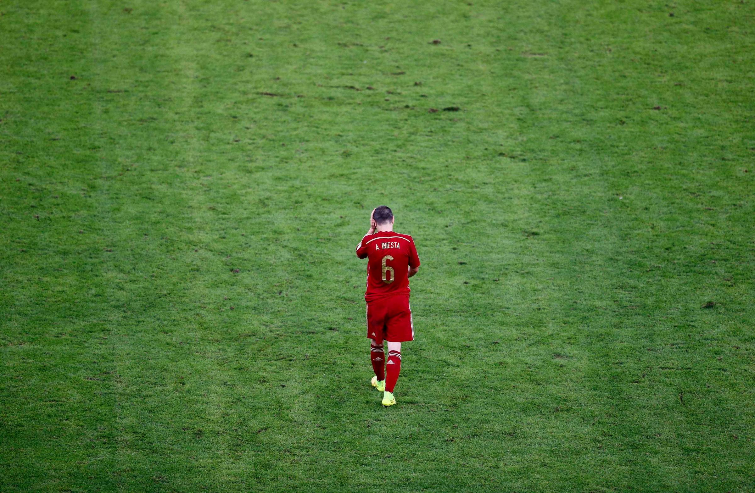Spain's Andres Iniesta walks on the pitch during the 2014 World Cup Group B soccer match between Spain and Chile at the Maracana stadium in Rio de Janeiro on June 18, 2014.