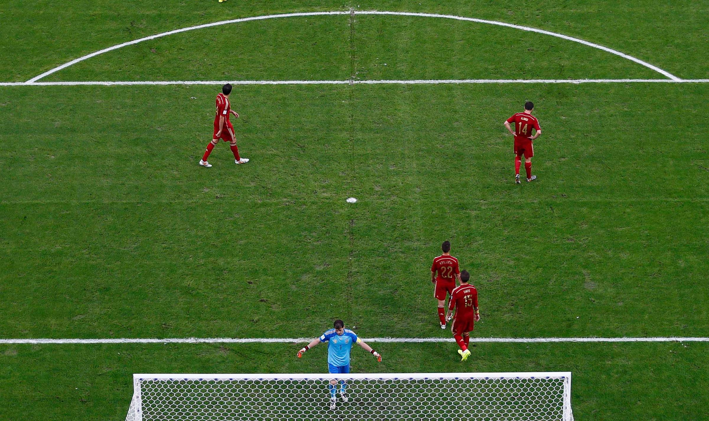 Spain players react after a goal by Chile's Eduardo Vargas during the 2014 World Cup Group B soccer match at the Maracana stadium in Rio de Janeiro on June 18, 2014.