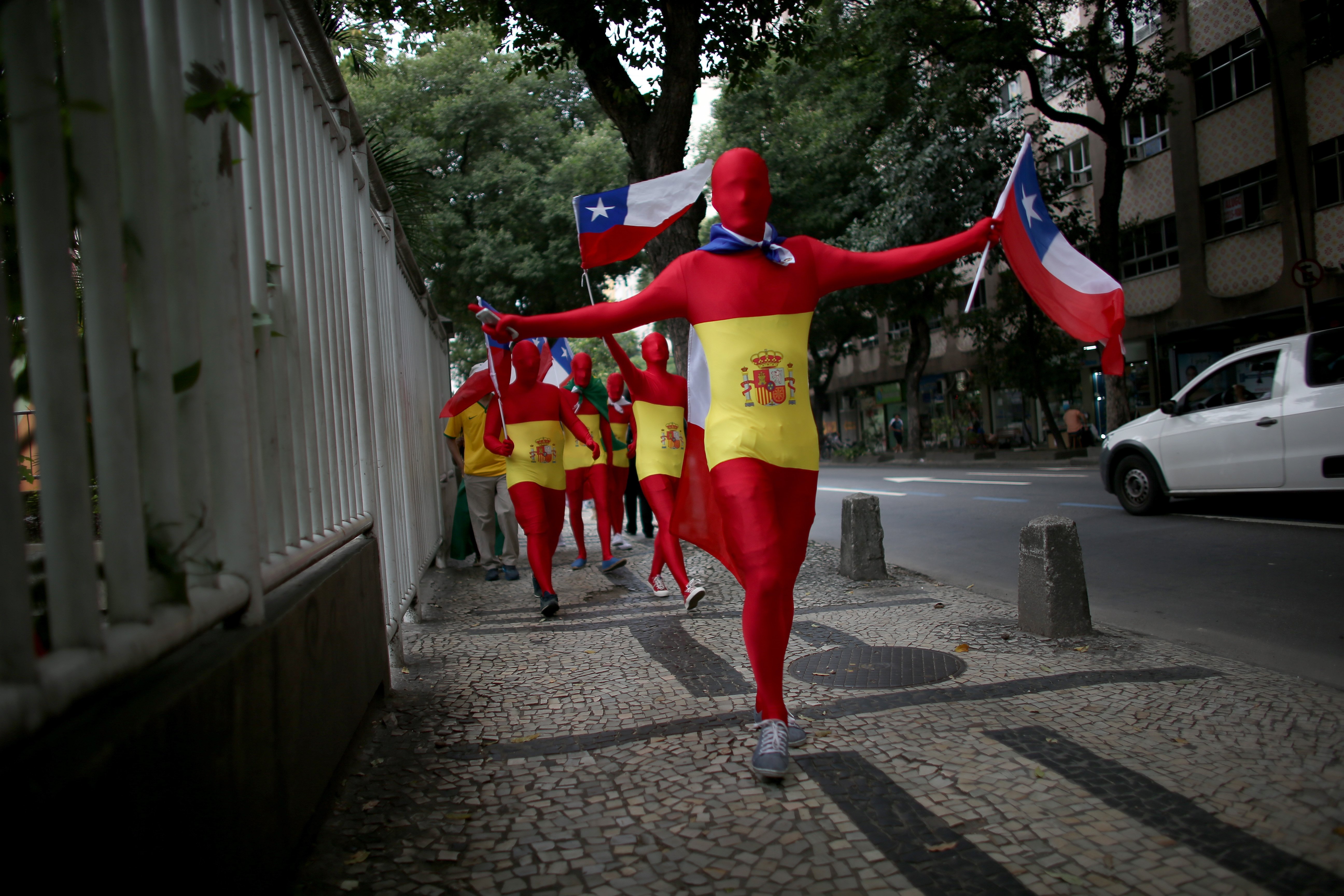 A group of Chilean soccer team fans walk through the streets as they wait for their team to play Spain during the FIFA World Cup tournament on June 18, 2014 in Rio de Janeiro.