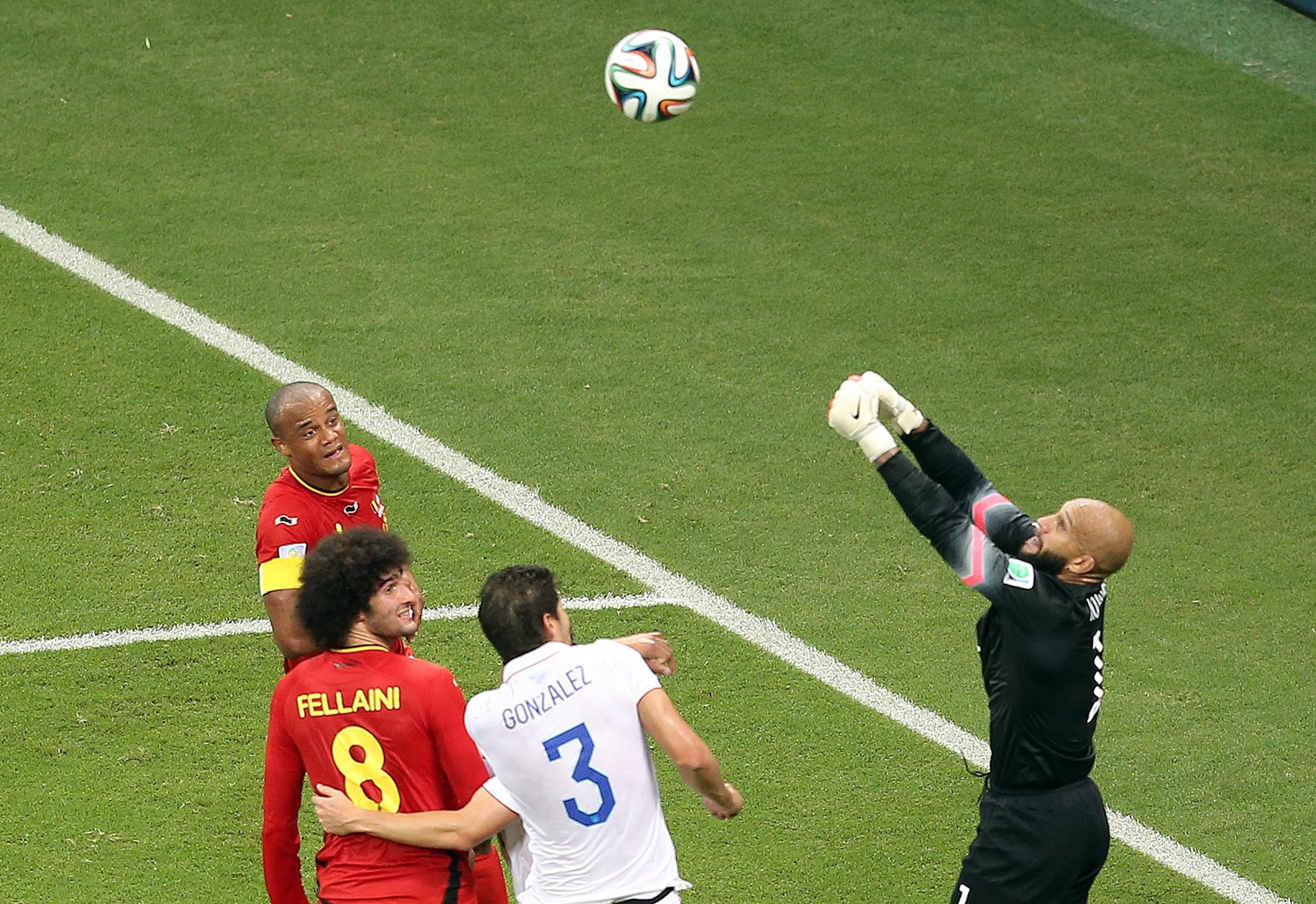 Goalkeeper Tim Howard of the USA (R) makes a save during a cooling break during the FIFA World Cup 2014 round of 16 match between Belgium and the USA at the Arena Fonte Nova in Salvador, Brazil on July 1, 2014.