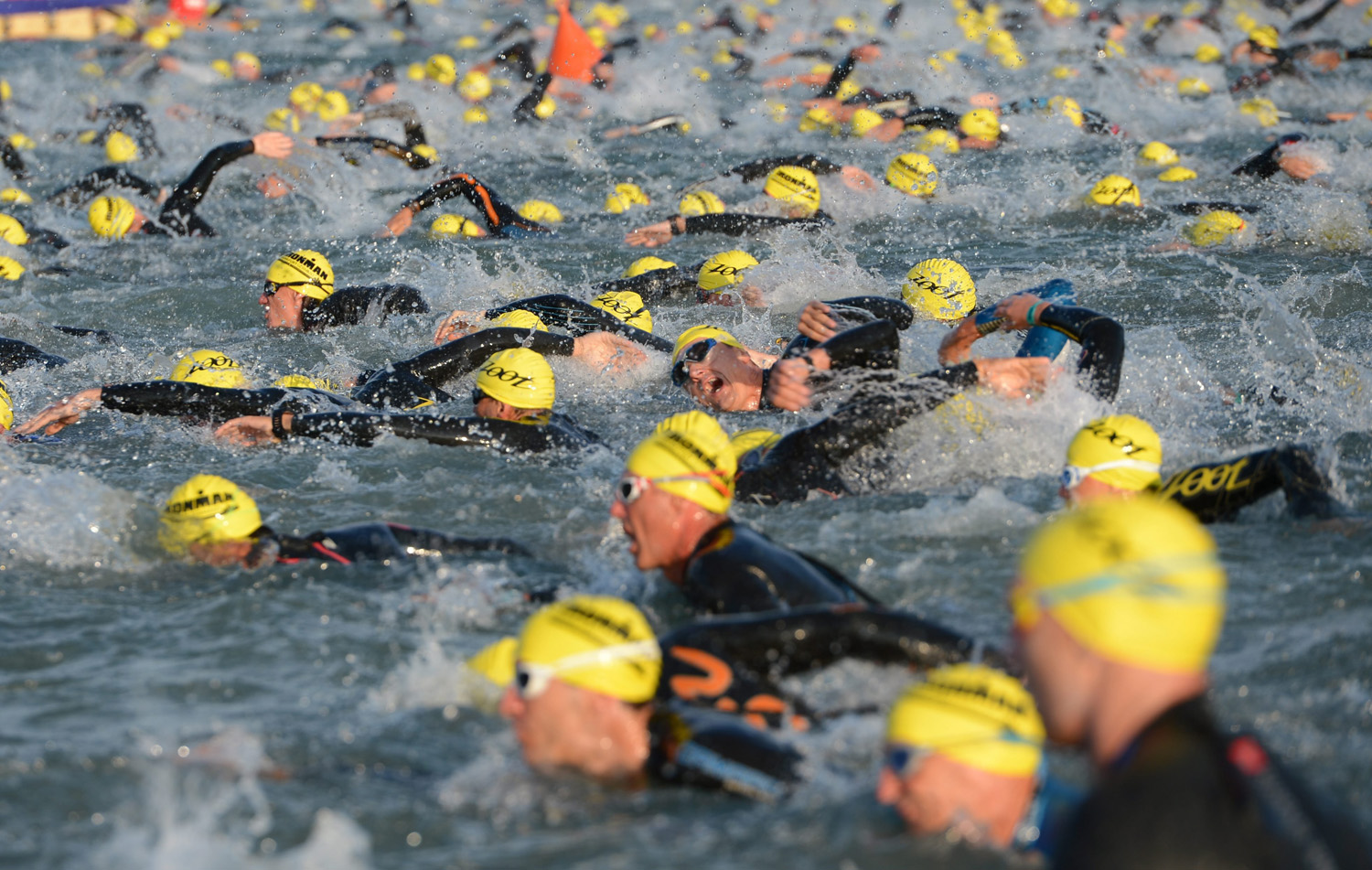 Participants plough the waters of the Forest Lake shortly after the start of the swimming stage of the Ironman European Championship in Langen, near Frankfurt, Germany, July 6, 2014.