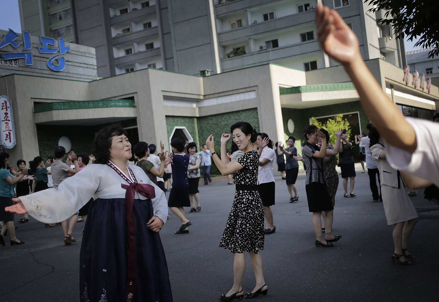 North Koreans  dance in downtown Pyongyang, Sunday, July 27, 2014 in North Korea.