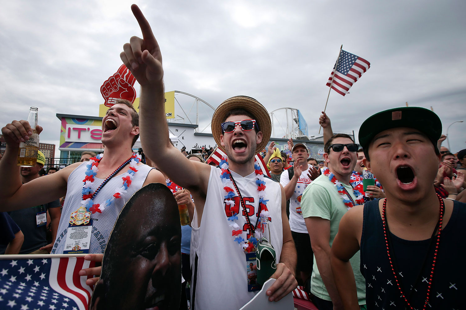 Jon Herzog, center, cheers at the Nathan's Famous Fourth of July International Hot Dog Eating contest at Coney Island.
