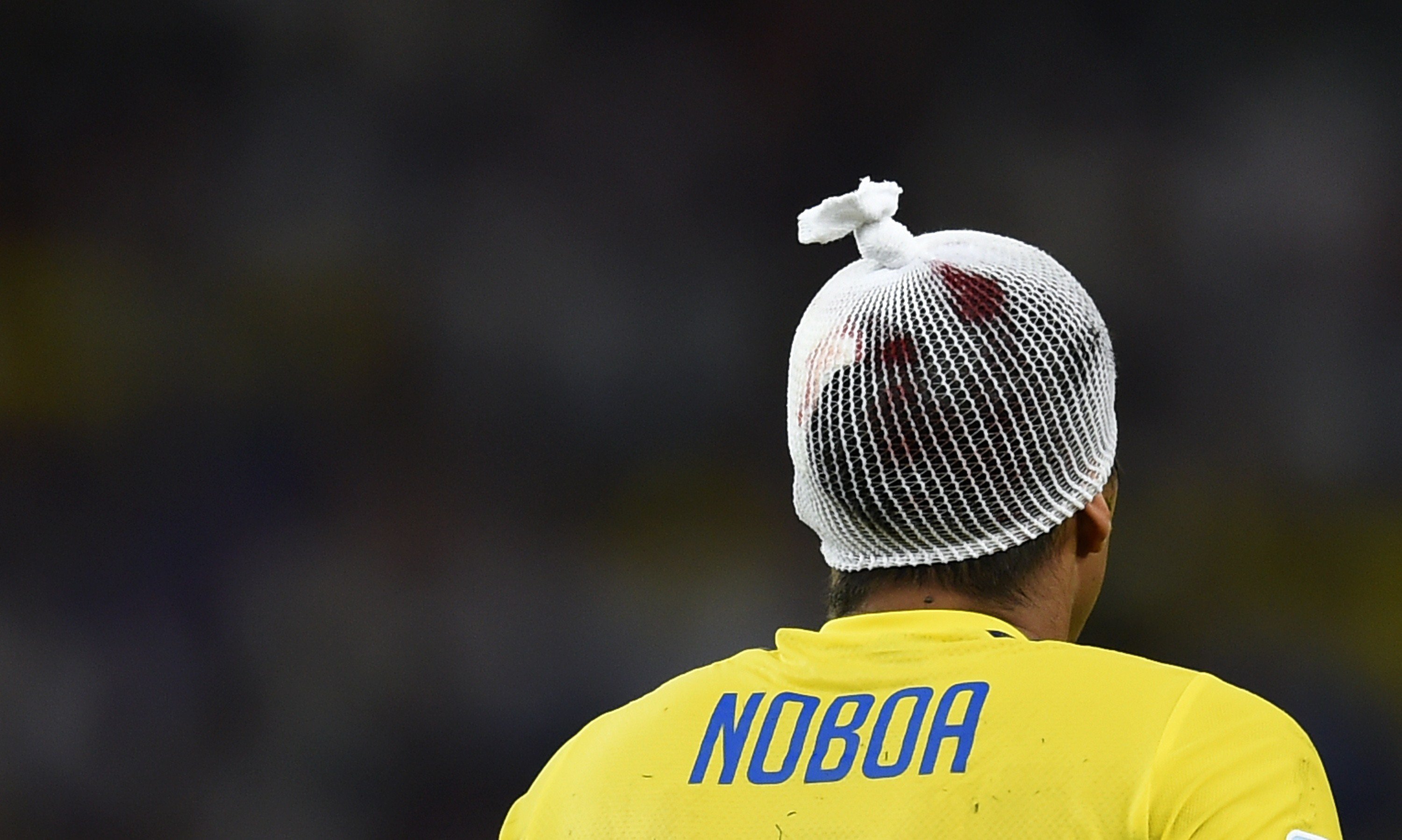 Ecuador's midfielder Christian Noboa wears a bandage after clashing his head during the match between Ecuador and France at the Maracana Stadium in Rio de Janeiro on June 25, 2014.