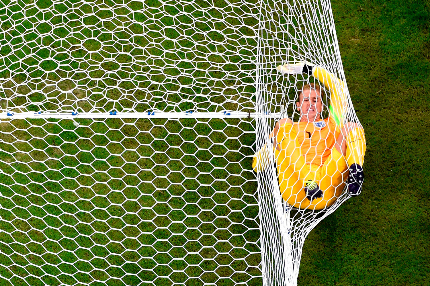 Joe Hart of England lands in the net after allowing Italy's second goal to Mario Balotelli of Italy during the match between England and Italy at Arena Amazonia on June 14, 2014 in Manaus, Brazil.
