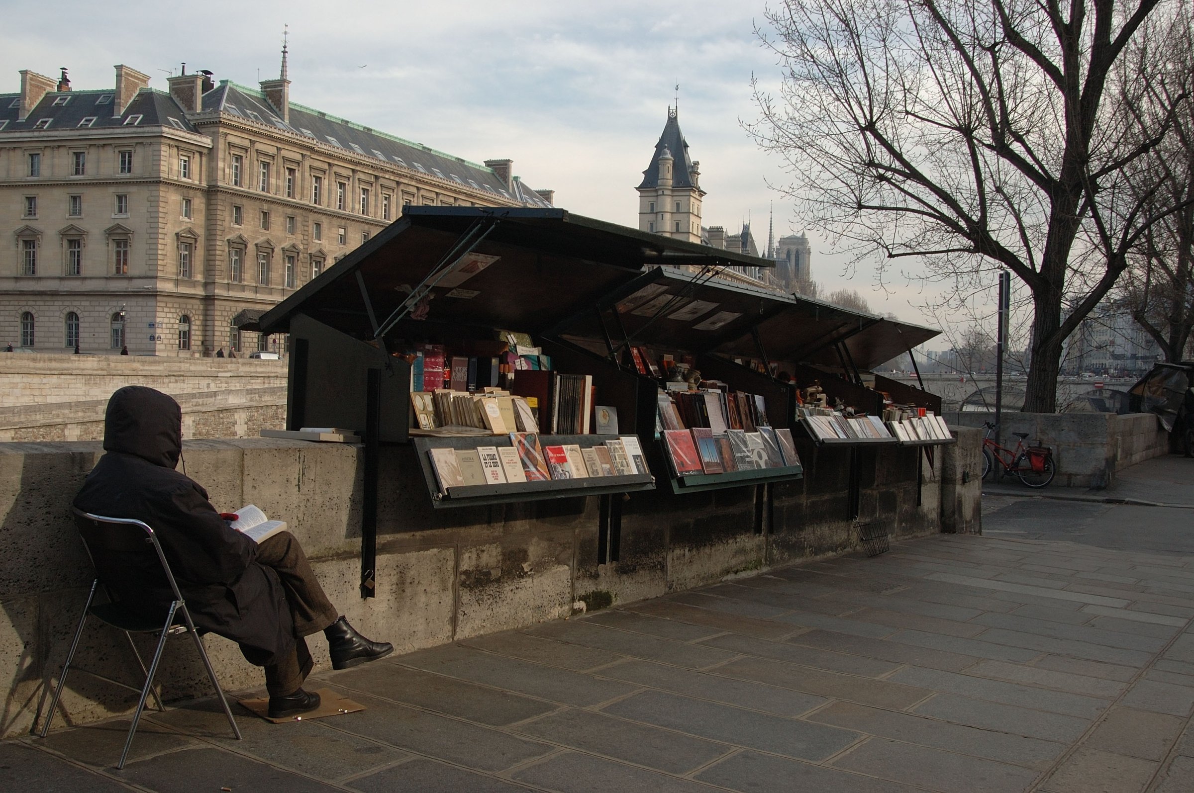 Booksellers On The Banks Of The Seine Opposite The Ile De La Cite In Paris, France In February, 2006 -