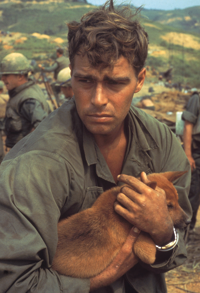 American cradling dog while under siege at Khe Sanh, Vietnam, 1968.