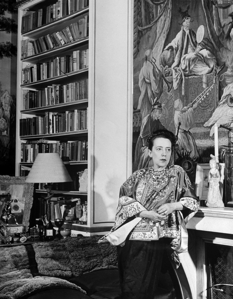 Fashion designer Elsa Schiaparelli in her study -- filled with treasures, paintings and books -- in Paris, 1947.