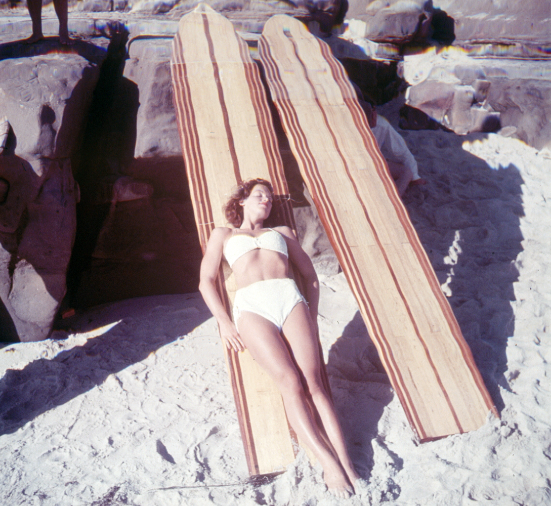 A long surfboard helps Marion Heatherly, 24, wife of a La Jolla, Calif., lifeguard deepen her suntan at Wind and Sea Cove.