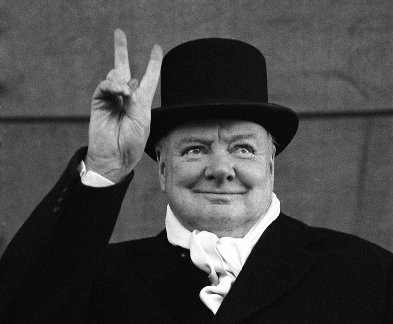 British Prime Minister Winston Churchill flashes his trademark "V for Victory" sign, 1951.