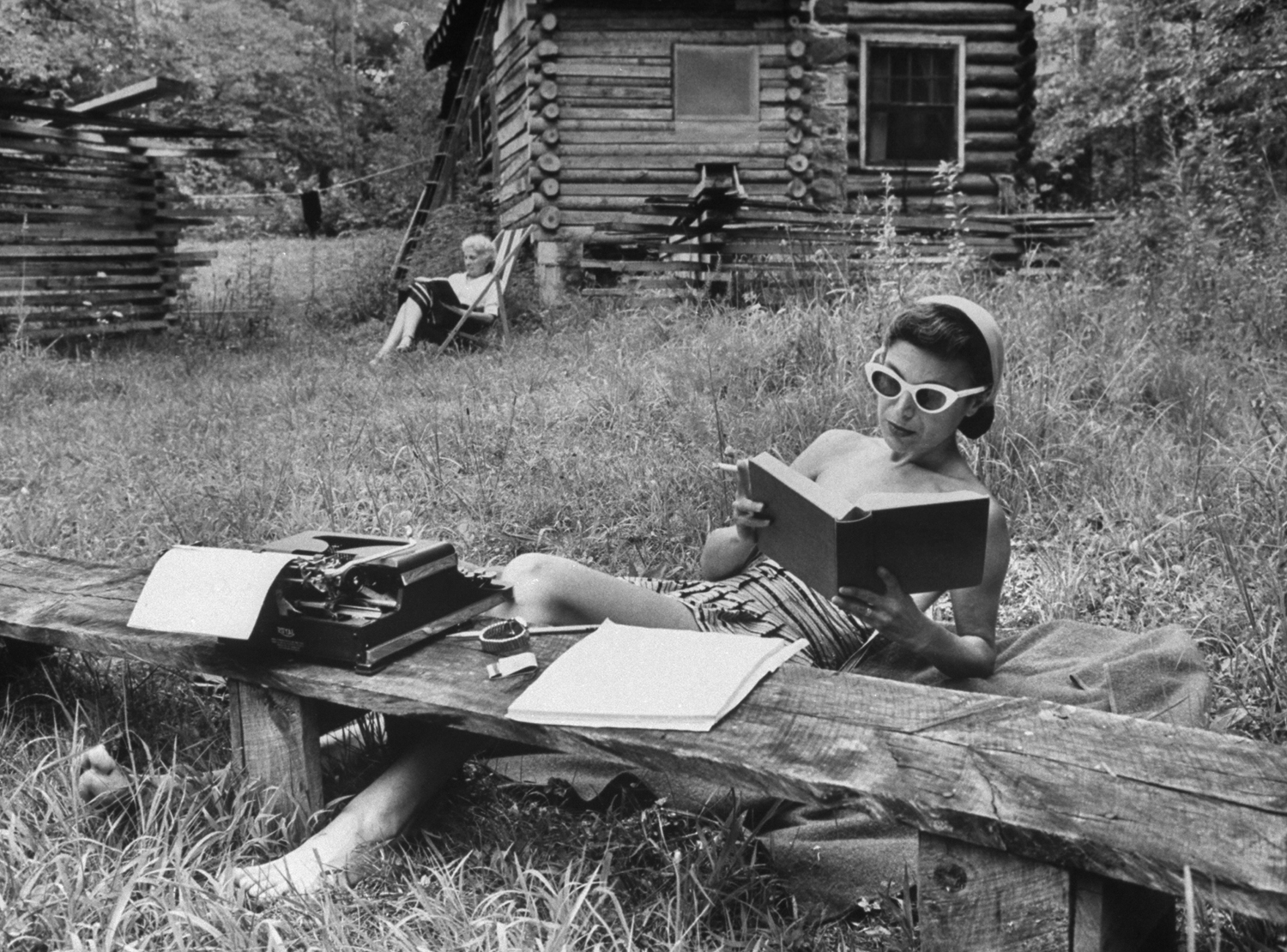 Relaxed writer, Mrs. Helen Lane of New Haven, Conn., checks word for story she is writing at Huckleberry Workshop near Hendersonville, N.C.