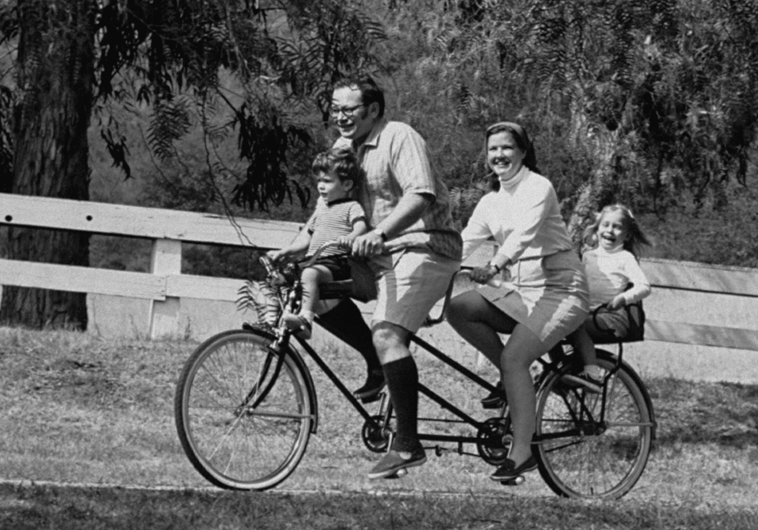 Nancy Lincoln, leukemia patient, with husband and two children, rides a bicycle-built-for-two in a California park, 1970.