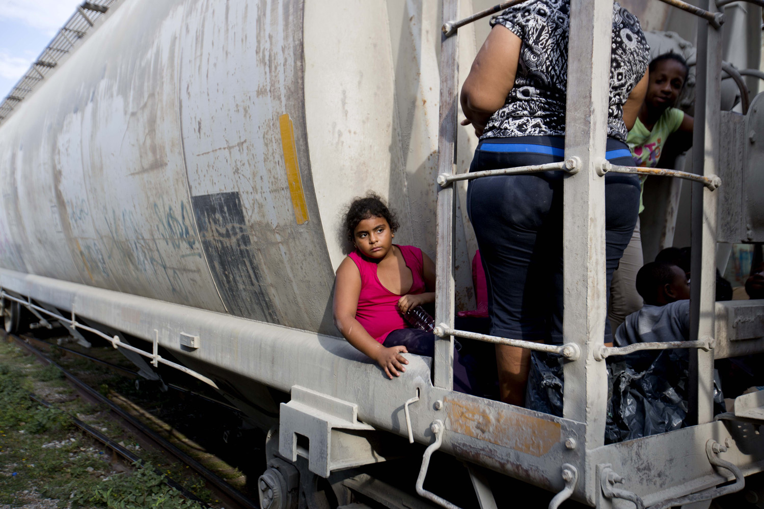 A young girl from Honduras waits for a northbound freight train to depart in Mexico as she makes her way to the U.S. border (Eduardo Verdugo—AP)