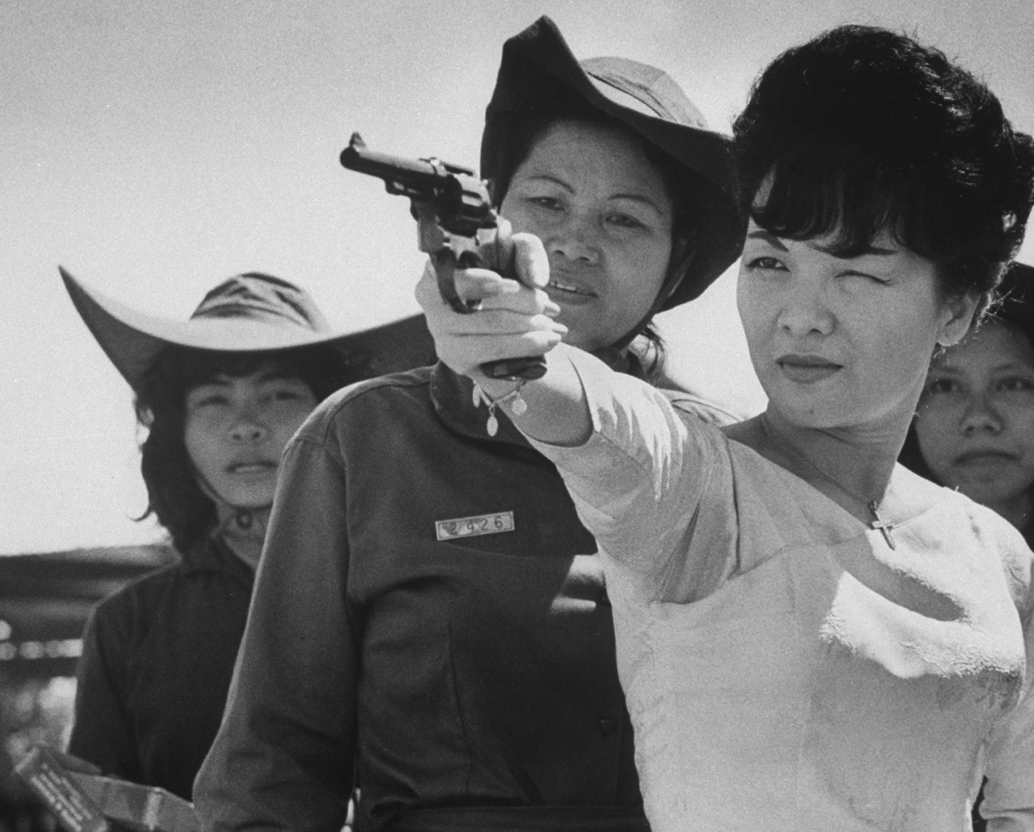 South Vietnam's Madame Nhu fires a pistol during a 1962 visit to an officer training session of the women's paramilitary force that she organized the year before.
