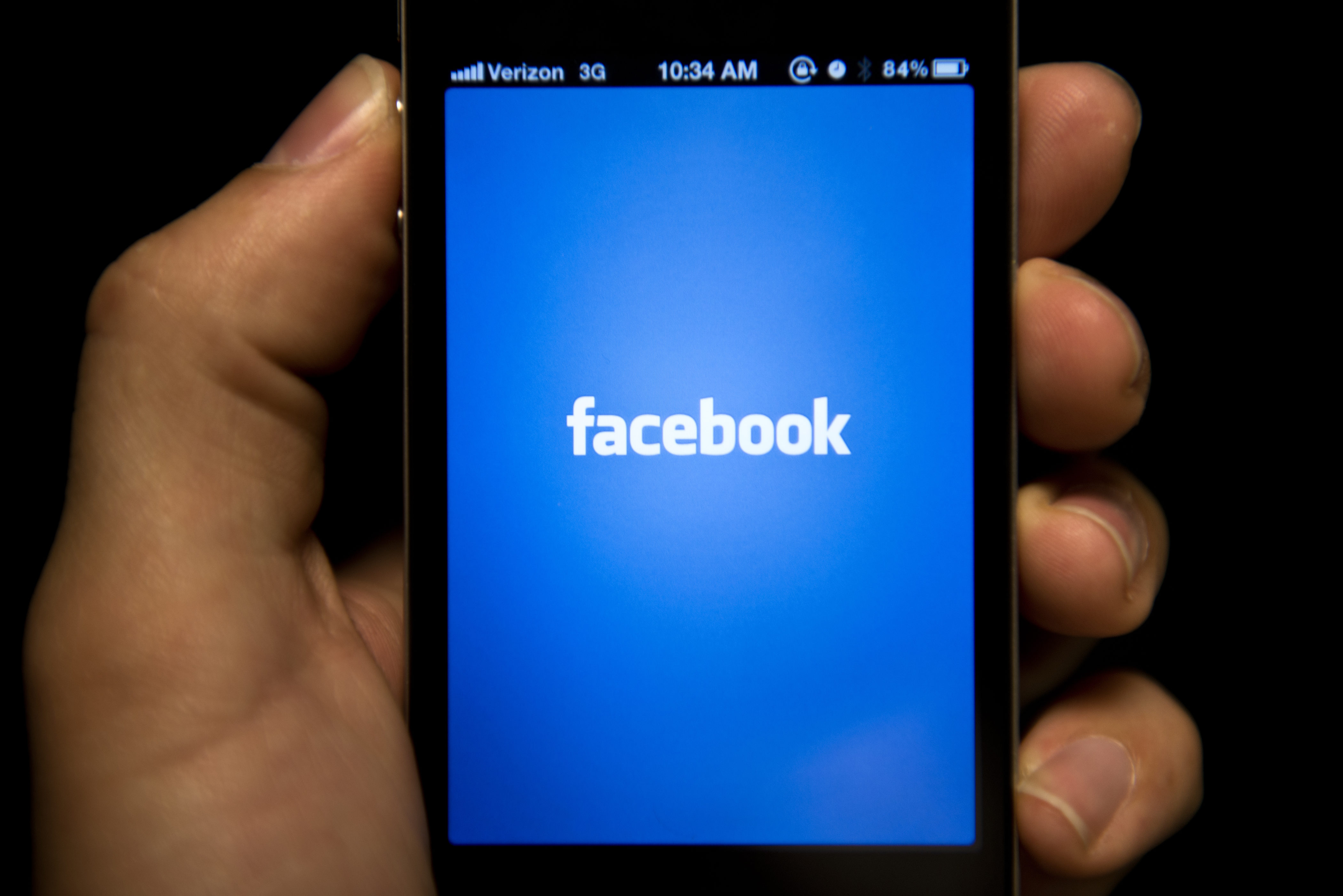 A view of an Apple iPhone displaying the Facebook app's splash screen, May 10, 2012 in Washington. (Brendan Smialowski—AFP/Getty Images)