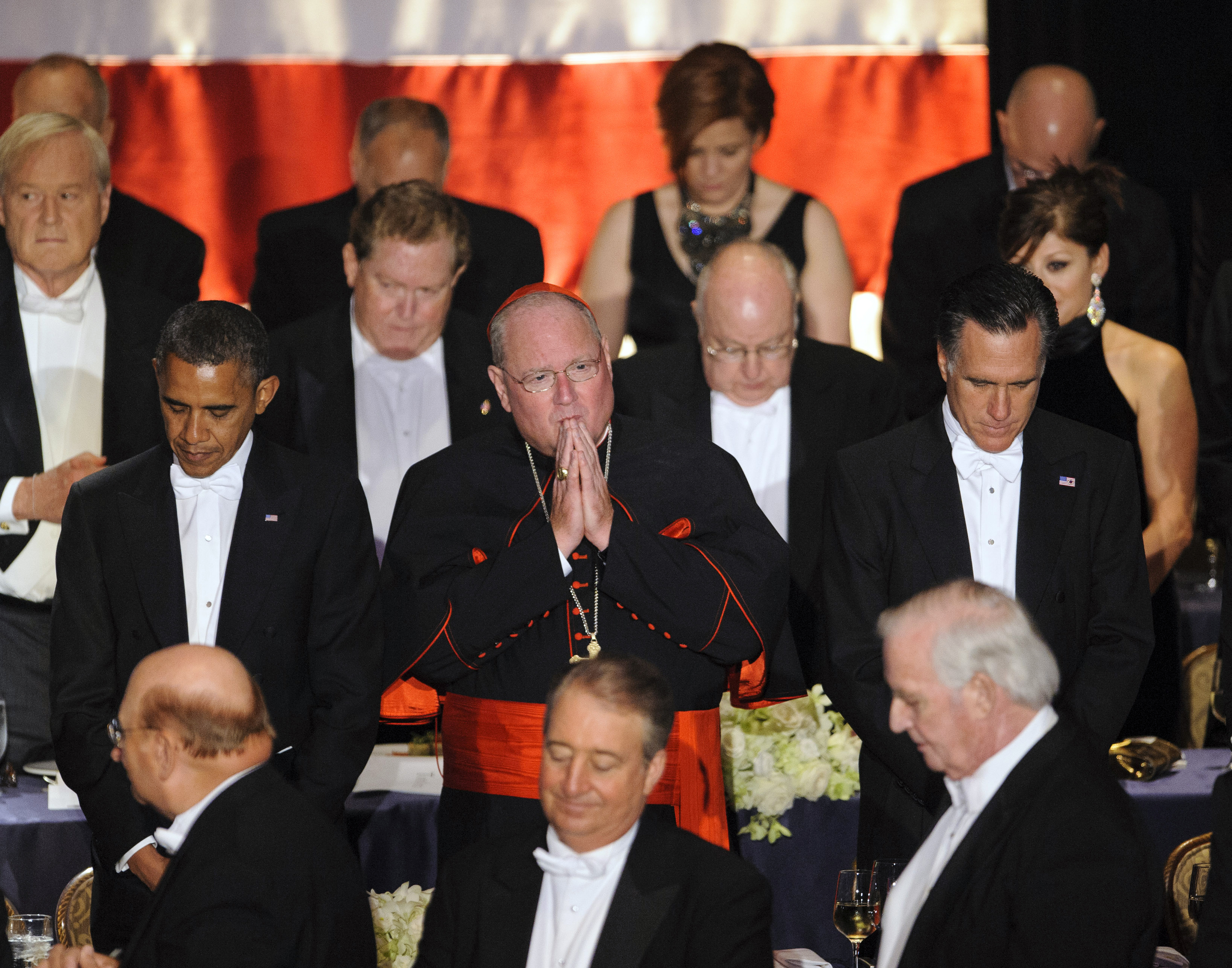 President Barack Obama, Cardinal Timothy Dolan, Archbishop of New York, and Republican presidential candidate Mitt Romney pray during the 67th Annual Alfred E. Smith Memorial Foundation Dinner at the Waldorf Astoria Hotel in New York. (New York Daily News—NY Daily News via Getty Images)