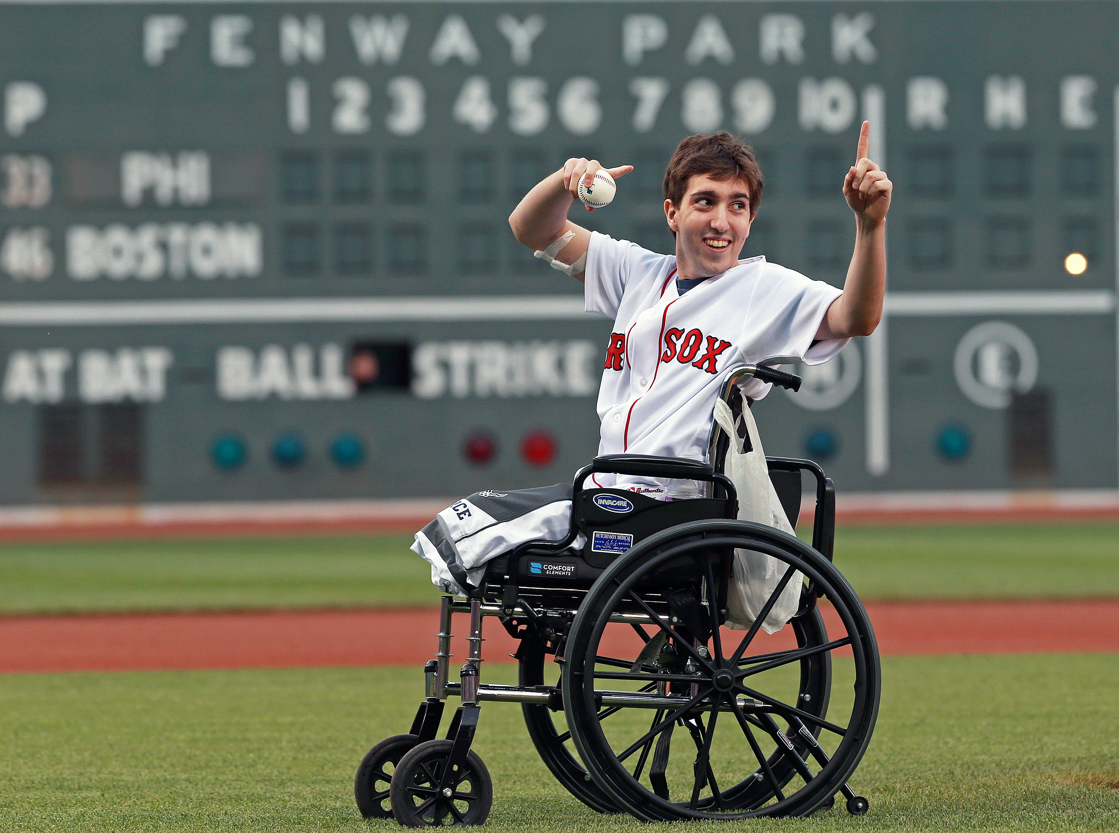 Boston Marathon bombing victim Jeff Bauman threw out a ceremonial first pitch on May 28, 2013, at Boston's Fenway Park, where the Philadelphia Phillies played the Red Sox in a regular-season baseball game. (Jim Davis—The Boston Globe/Getty Images)