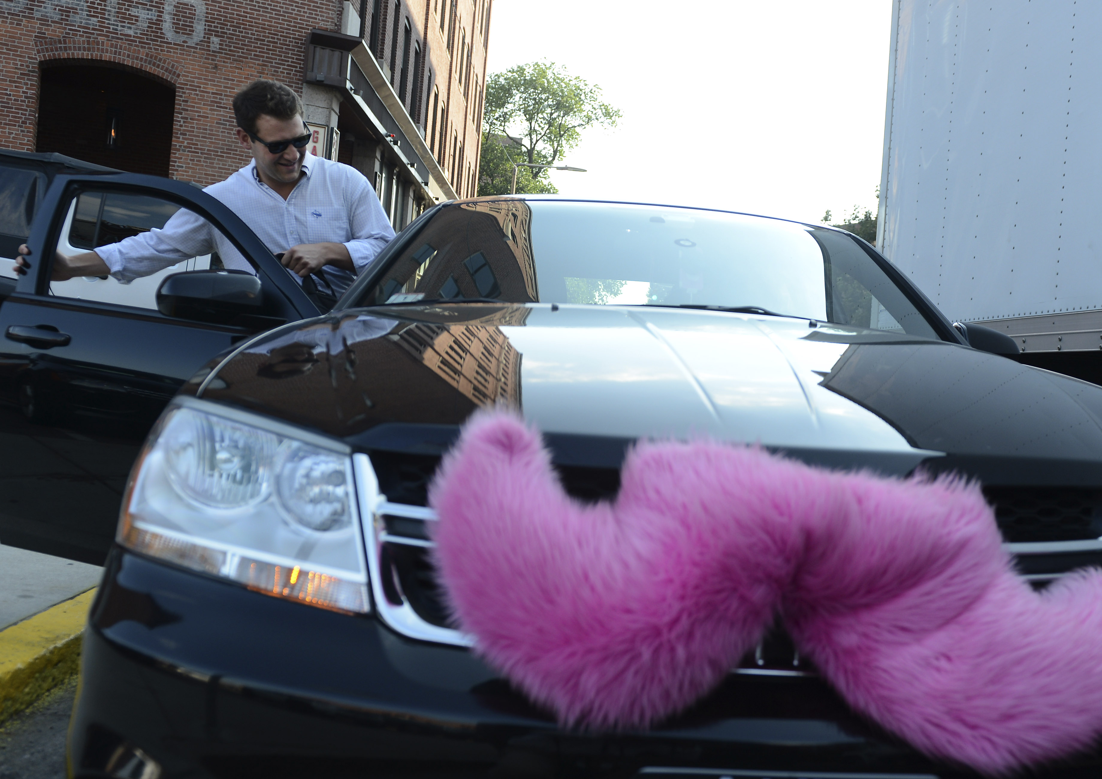 Hunter Perry, a regular Lyft user, gets picked up on July 16, 2013 near his office on Harrison Avenue. (Boston Globe—Boston Globe/Getty Images)