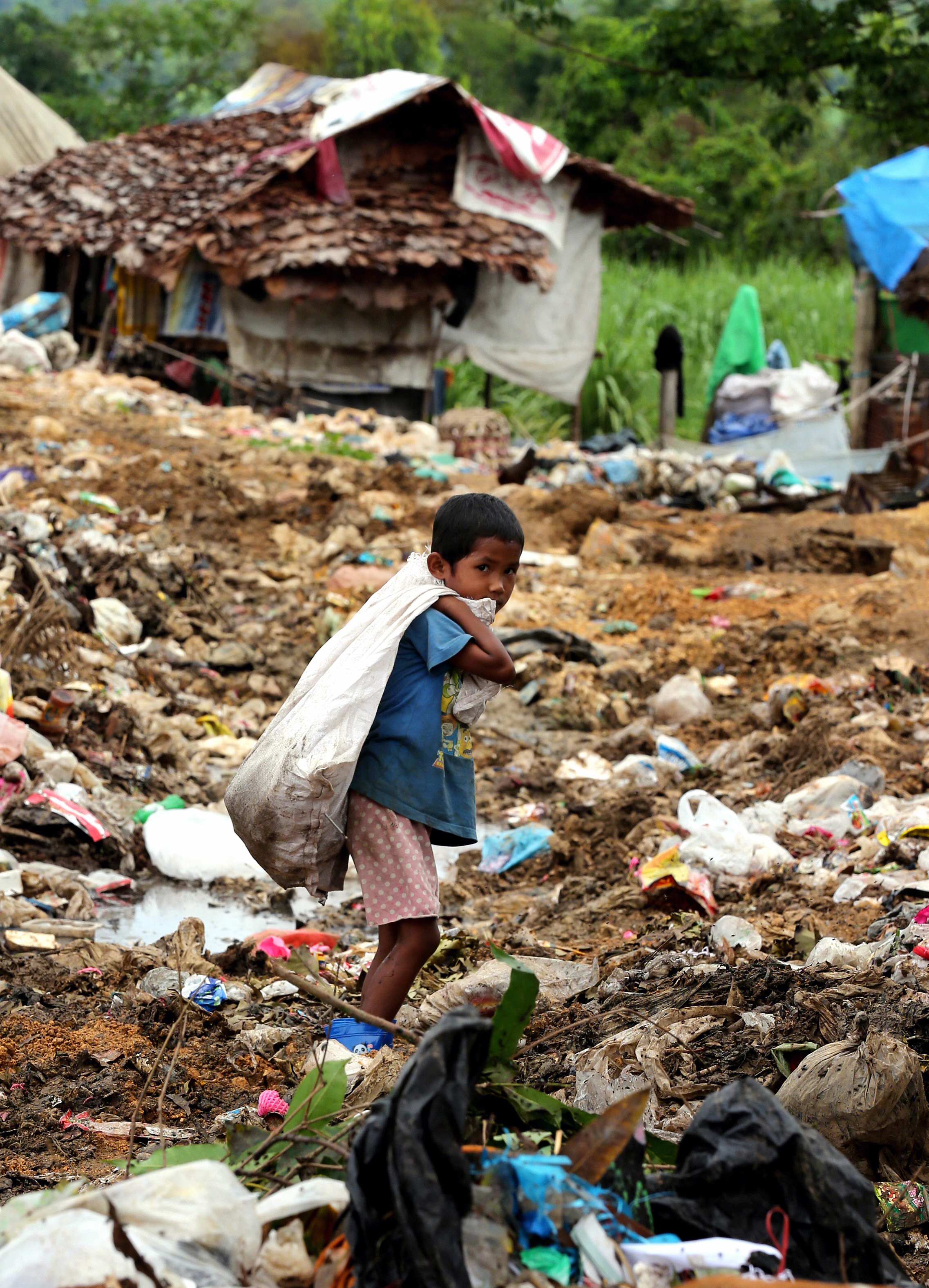 An illegal-immigrant boy from Burma works at mountains of rubbish in Mae Sot, Thailand, on July 18, 2013 (The Asahi Shimbun—Getty Images)
