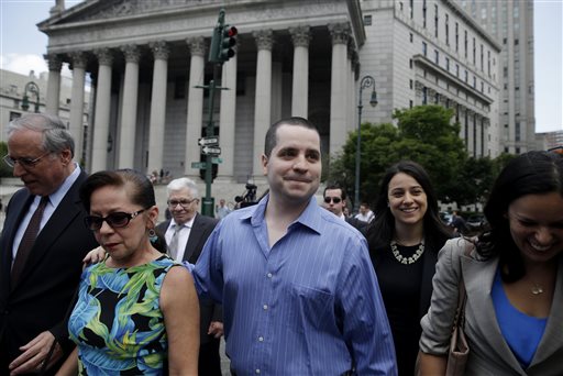 GIlberto Valle, center, leaves Manhattan federal court in New York on Tuesday, July 1, 2014.  