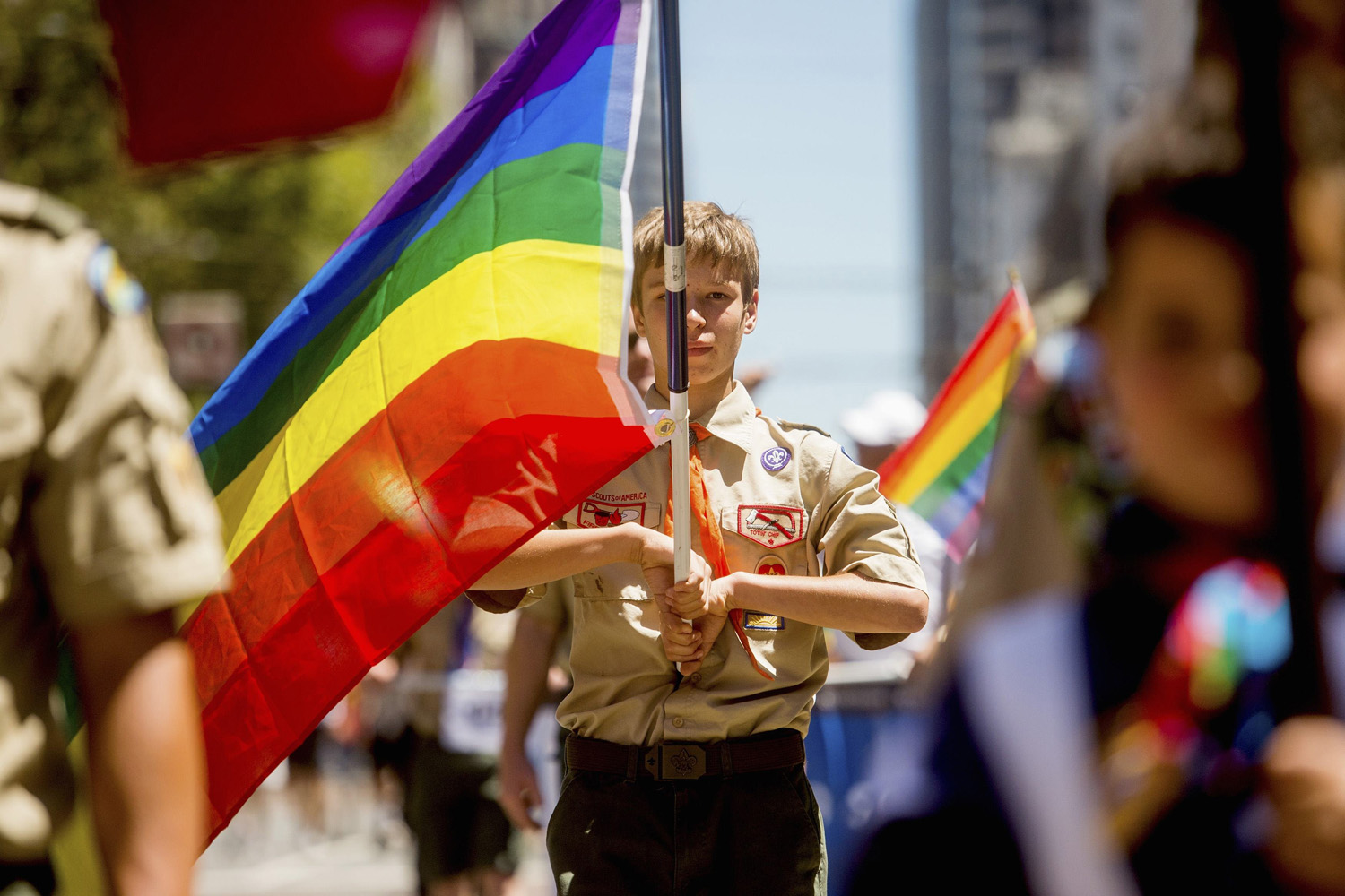 Boy Scout Casey Chambers carries a rainbow flag during the San Francisco Gay Pride Festival in California