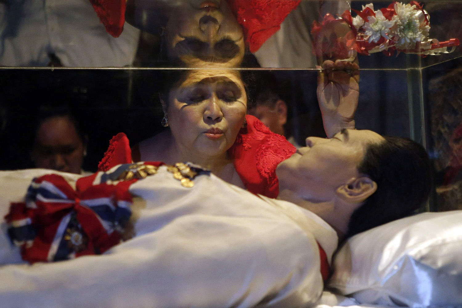 Jul. 2, 2014. Former first lady Imelda Marcos kisses the glass coffin of her husband, late president Ferdinand Marcos, who remains unburied since his death in 1989, during her 85th birthday celebration in Ferdinand Marcos' hometown of Batac, Ilocos Norte province, in northern Philippines.
