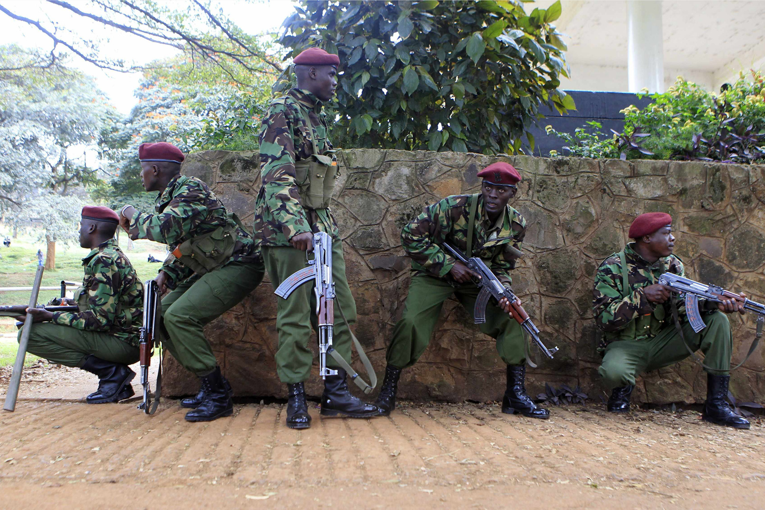 Policemen from the GSU take cover from stone throwing youths during the "Saba Saba Day" rally at the Uhuru park grounds in the capital Nairobi