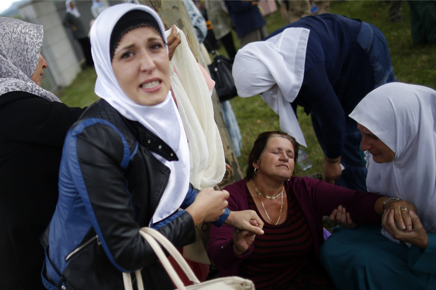 A Bosnian Muslim woman reacts near where 175 coffins of newly identified victims from the 1995 Srebrenica massacre are placed, in Potocari Memorial Center, near Srebrenica