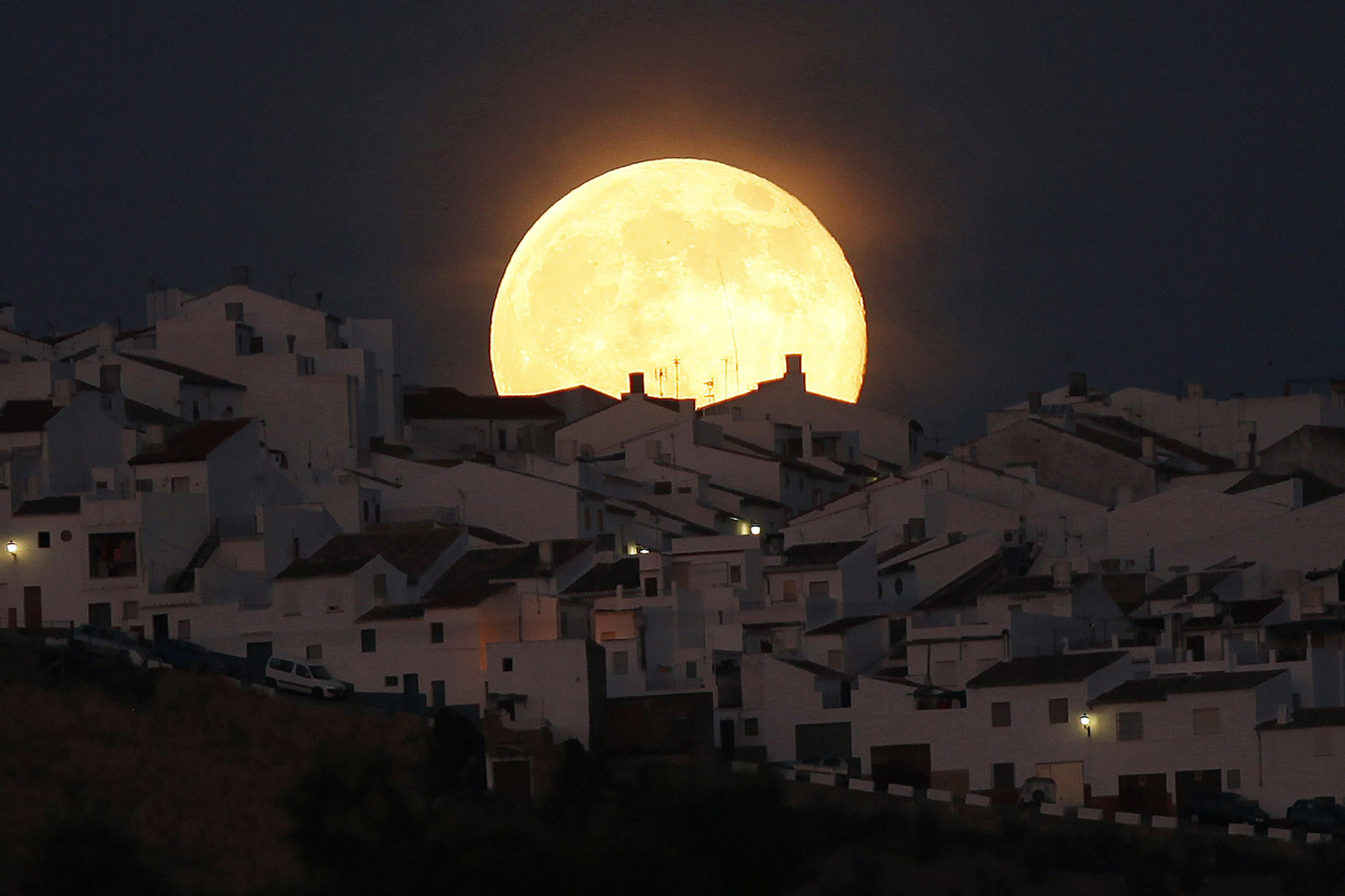The Supermoon rises over houses in Olvera, Spain on July 12, 2014.