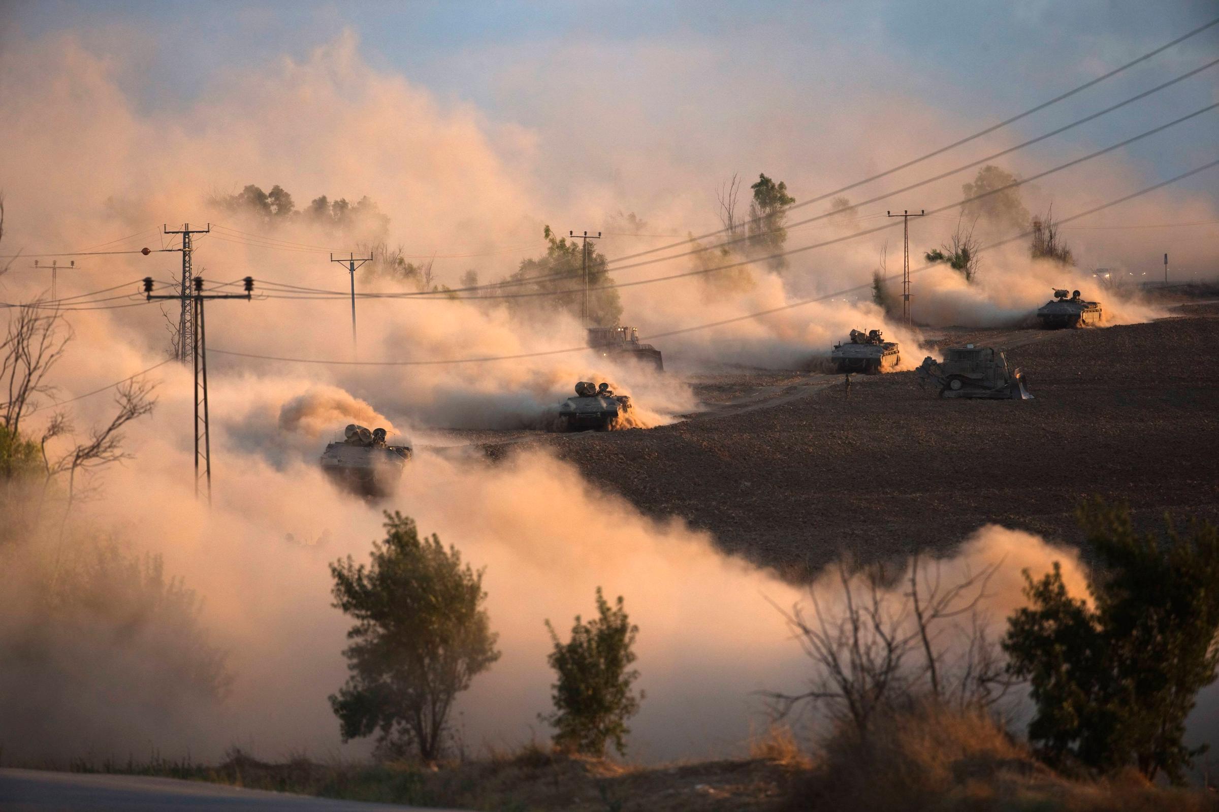 Israeli tanks maneuver outside the Gaza Strip on July 18, 2014.