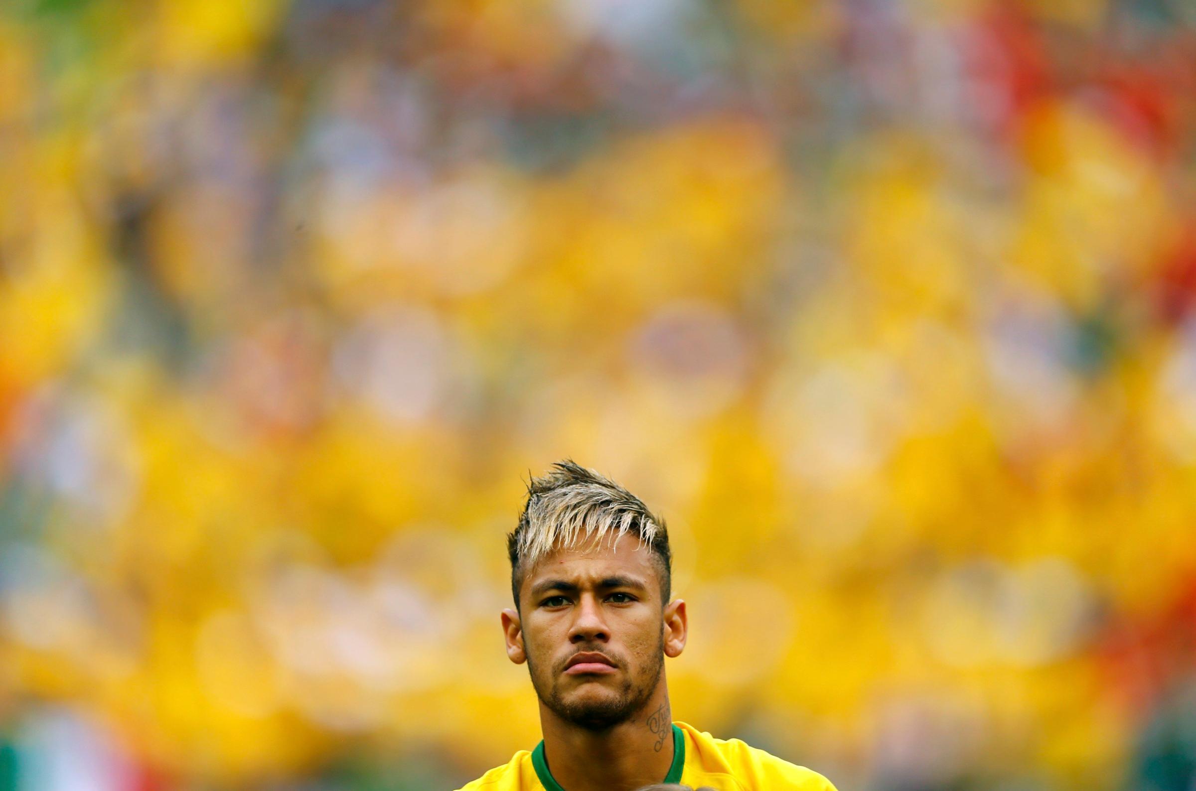 Brazil's Neymar stands during the 2014 World Cup Group A soccer match between Brazil and Mexico at the Castelao arena
