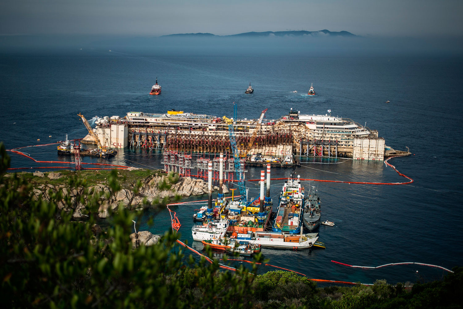 The Costa Concordia wreck re-float operation on July 21, 2014 in Giglio Porto, Italy. The 114,500 ton ship ran aground in January of 2012. The ships captain could face 20 years in prison.