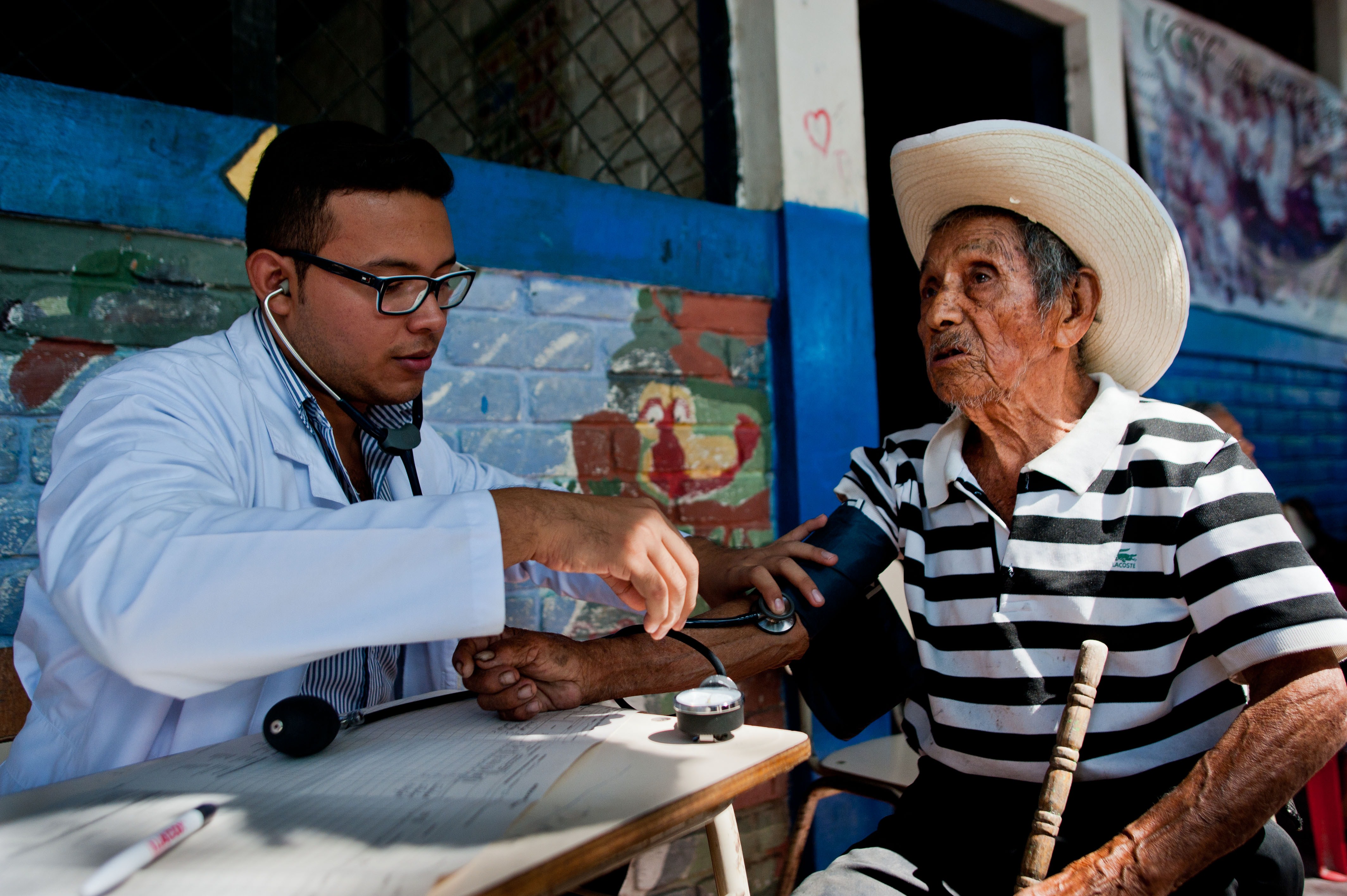 A doctor examines a patient during a medical brigade to detect suspicious cases of Chikungunya fever in a school of the town of Ayutuxtepeque, 4 km north of San Salvador, El Salvador on June 18, 2014. (Jose Cabezas—AFP/Getty Images)