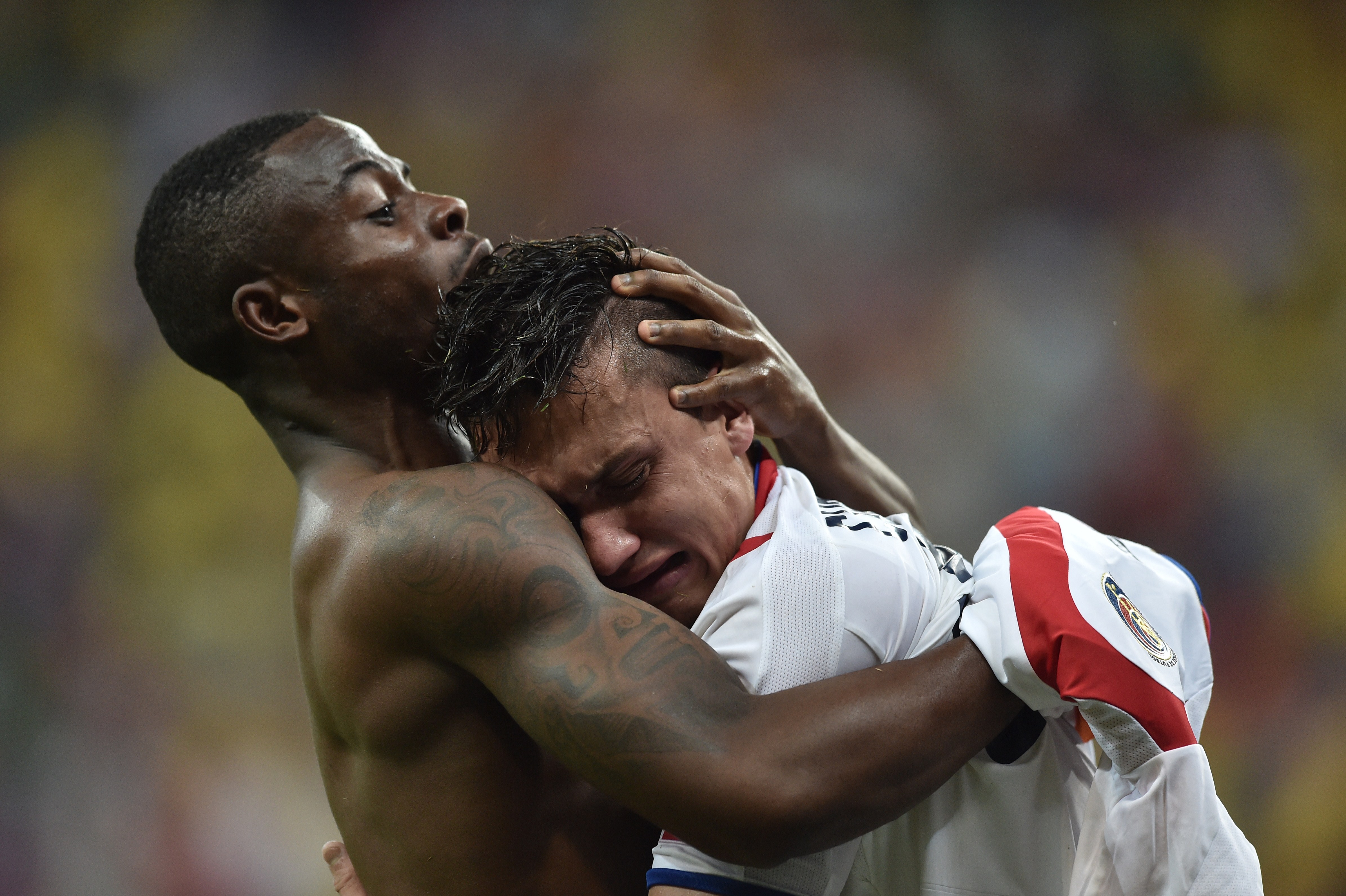 Costa Rica's defender Waylon Francis (L) and Costa Rica's midfielder Jose Miguel Cubero celebrate after winning a match with Greece during the 2014 FIFA World Cup on June 29, 2014. (ARIS MESSINIS—AFP/Getty Images)