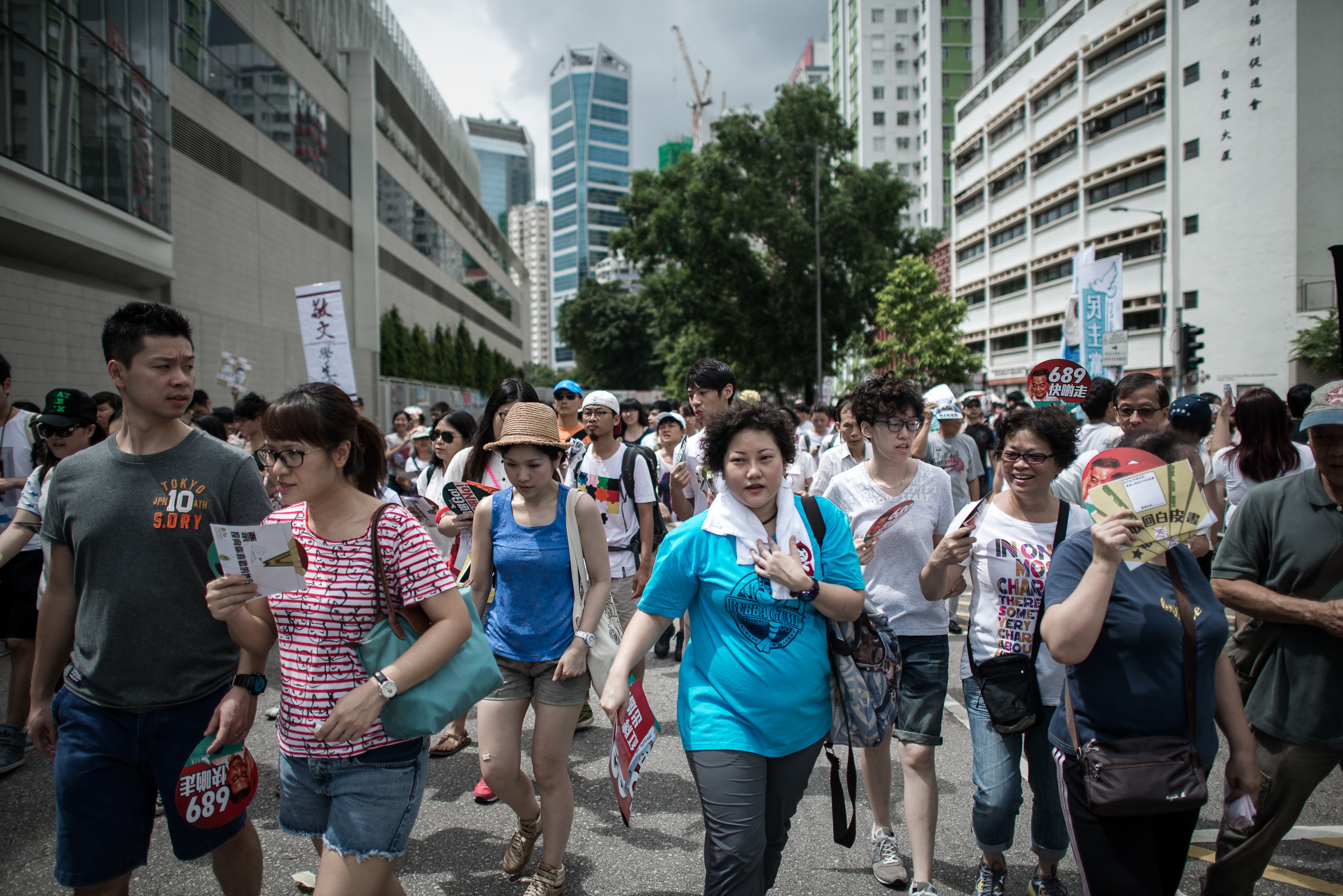 Demonstrators walk on their way to join a pro-democracy rally seeking greater democracy in Hong Kong on July 1, 2014 (Philippe Lopez—AFP/Getty Images)