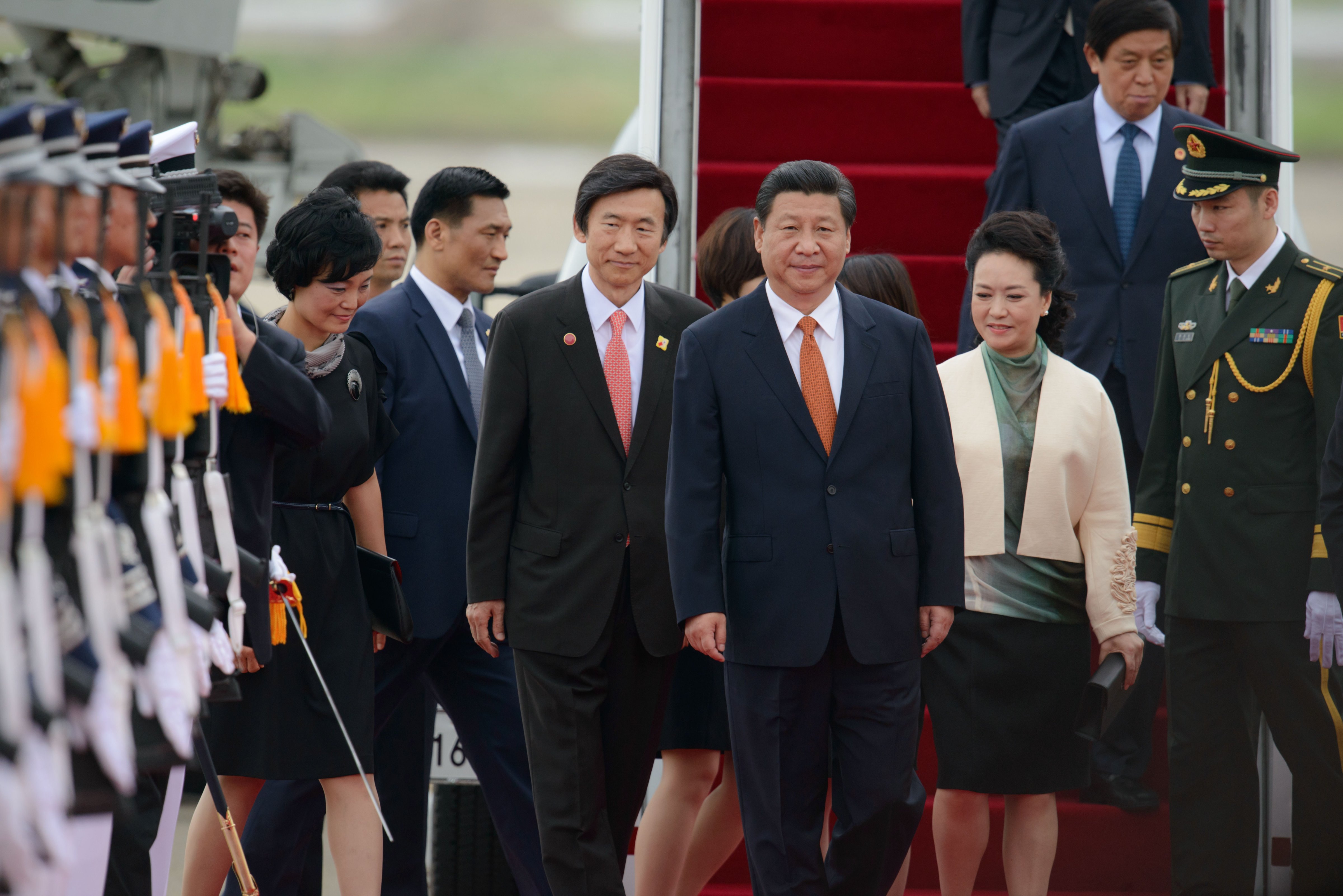 China's President Xi Jinping and his wife Peng Liyuan are welcomed upon arrival at Seoul Air Base on July 3, 2014 (Ed Jones—AFP/Getty Images)