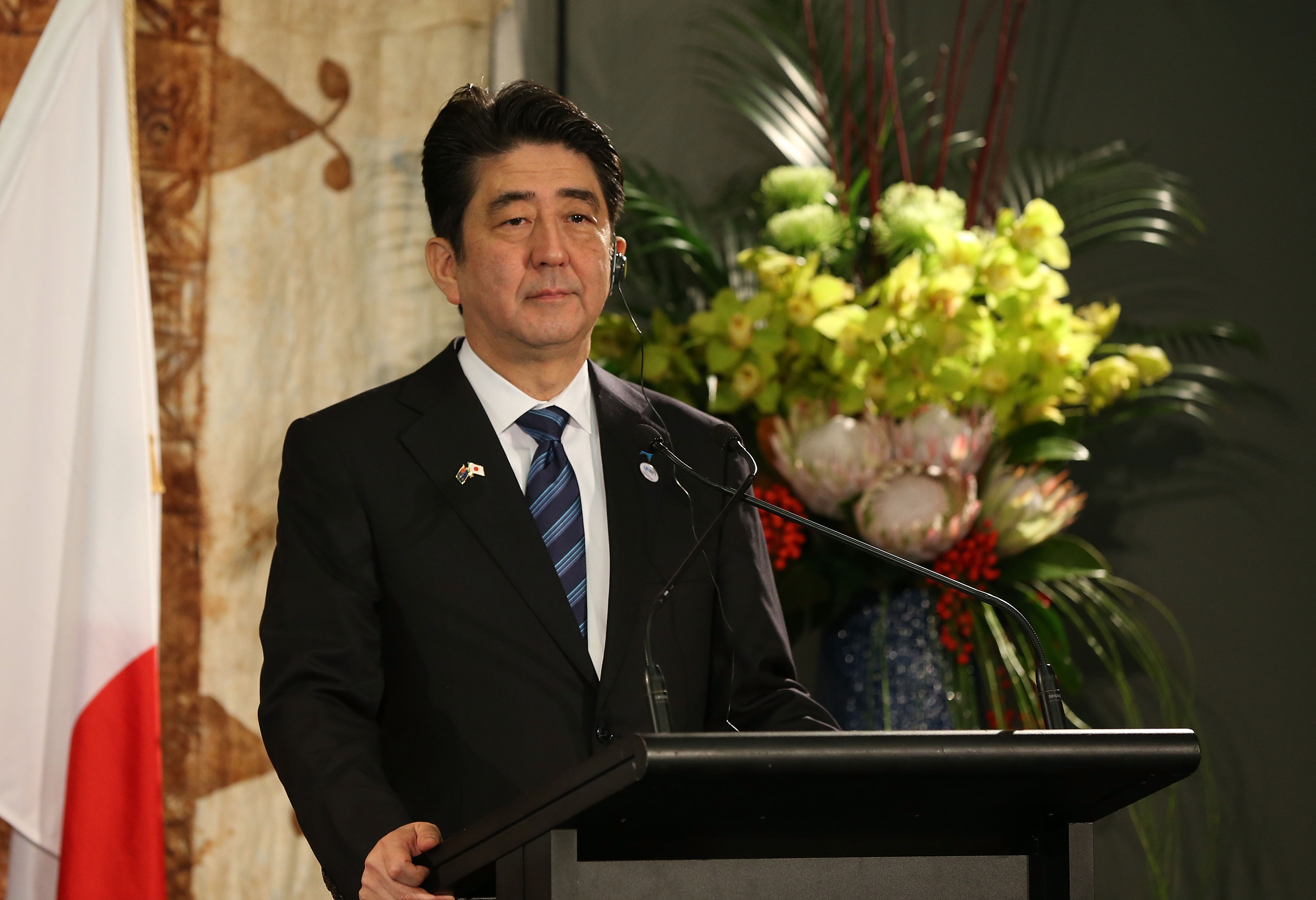Japanese Prime Minister Shinzo Abe speaks to the media after a traditional Maori welcome at Government House and talks with New Zealand Prime Minister John Key on July 7, 2014, in Auckland. (Fiona Goodall—Getty Images)
