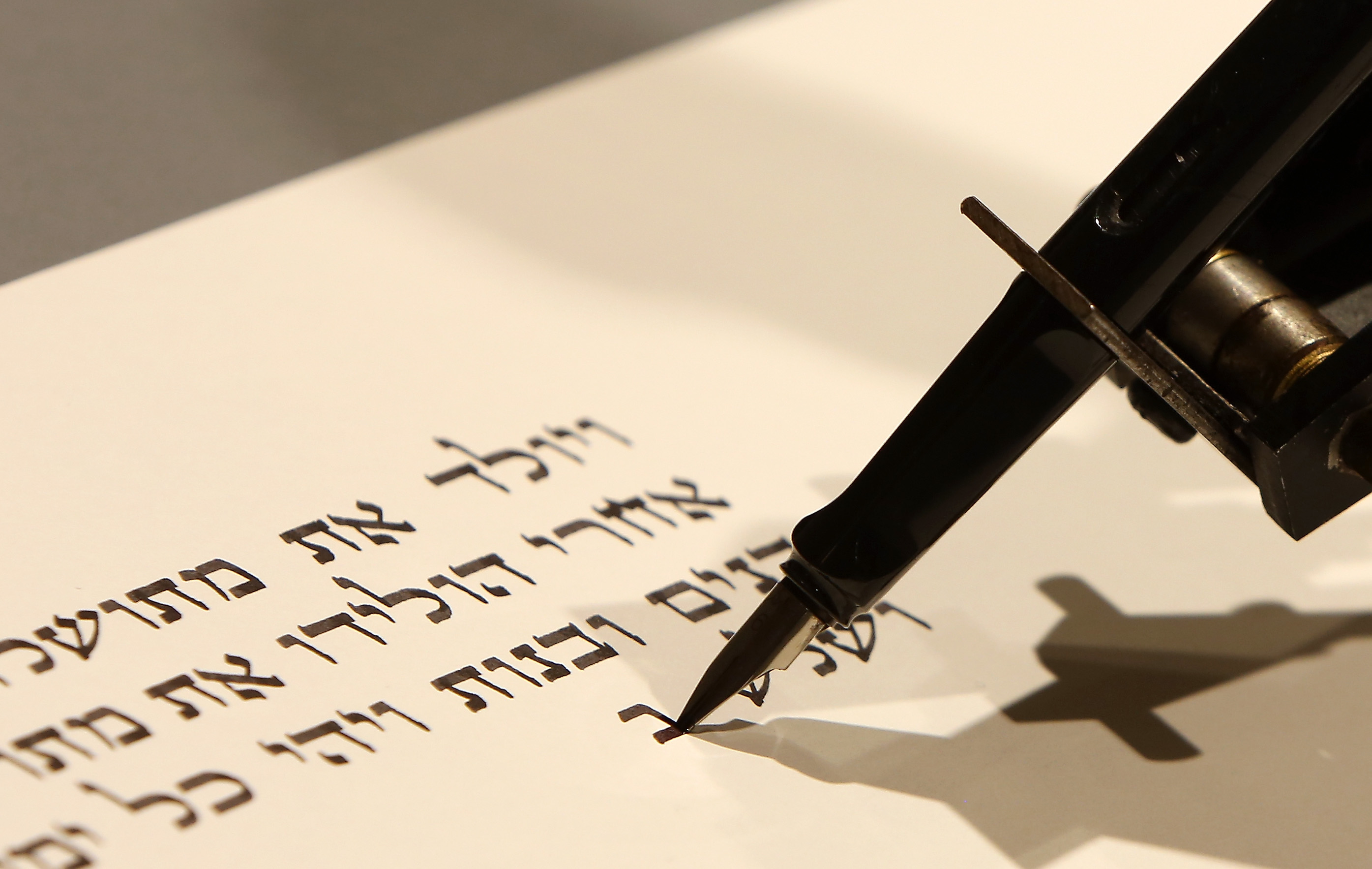 An industrial robot, an installation work called 'bios [torah]' by the artist group robotlab, begins writing a Torah on July 10, 2014 in the Jewish Museum in Berlin, Germany. (Adam Berry—Getty Images)